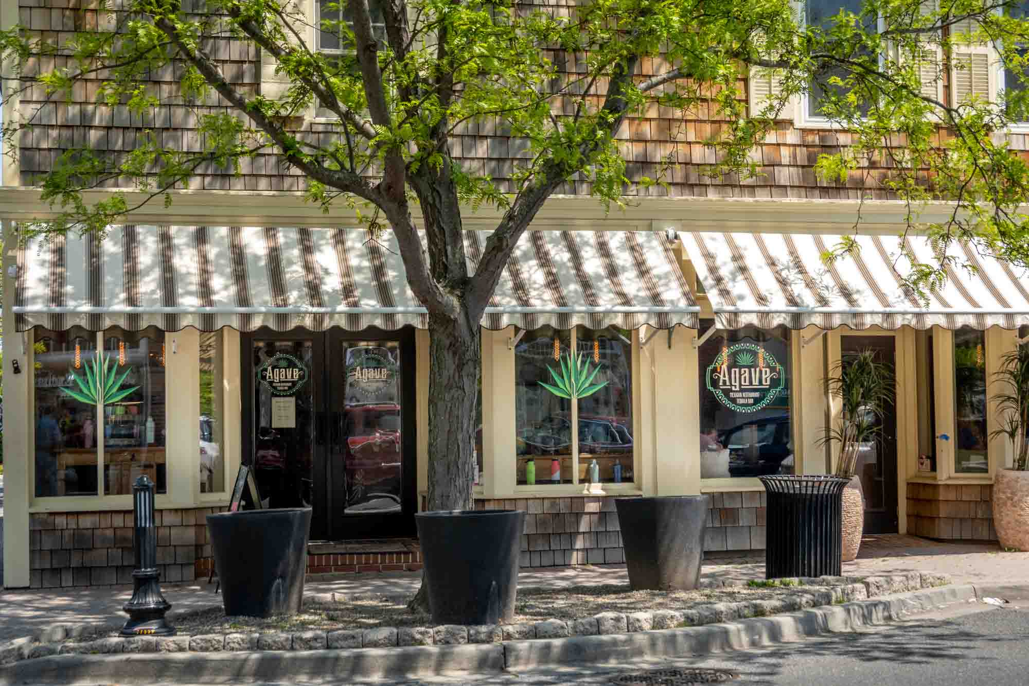 Exterior of a restaurant with a striped awning