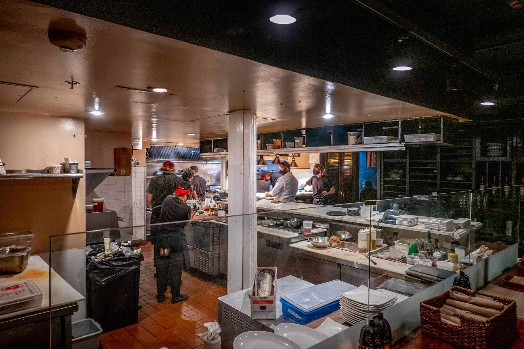 Employees in open restaurant kitchen