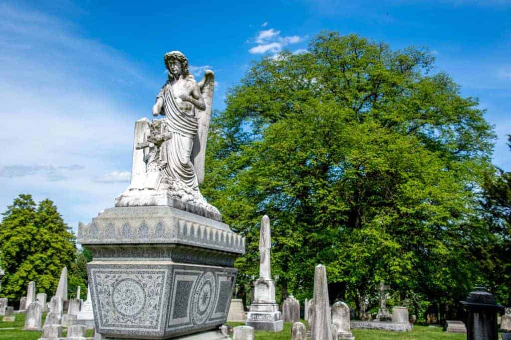 Angel sculpture on a gray tomb at Laurel Hill Cemetery