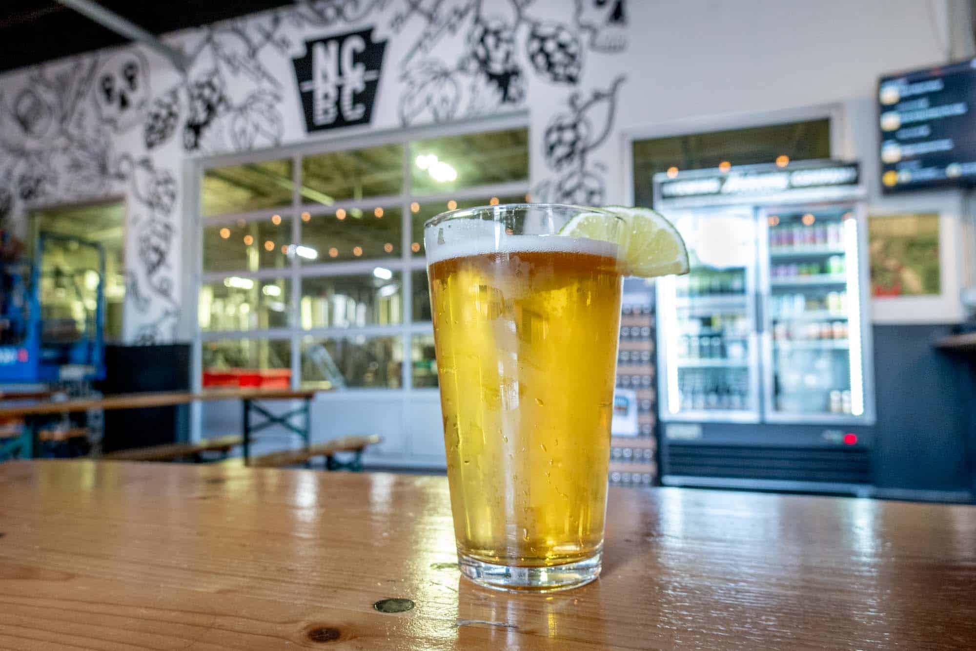 Mexican lager with lime wedge on table