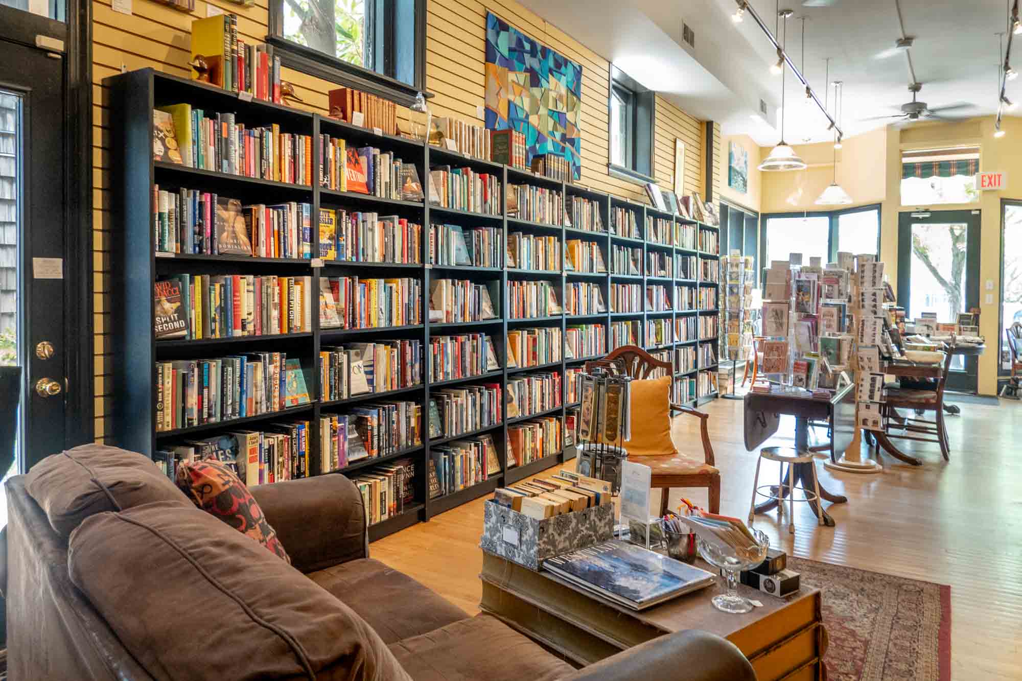Bookstore filled with shelves of books, greeting cards displays, and a couch