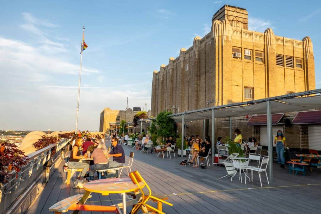 People sitting at tables at a rooftop bar