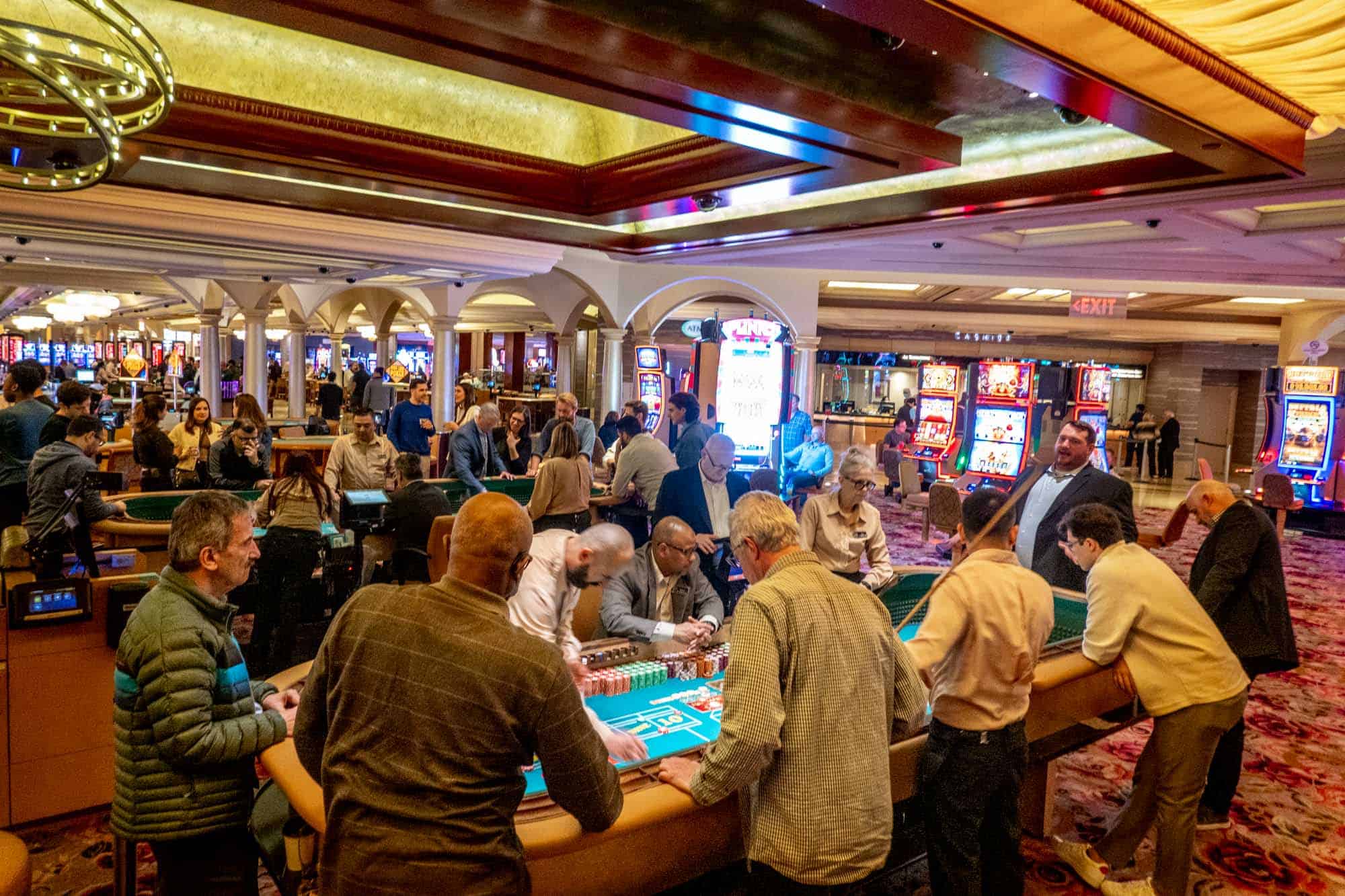 People playing at a craps table in a casino