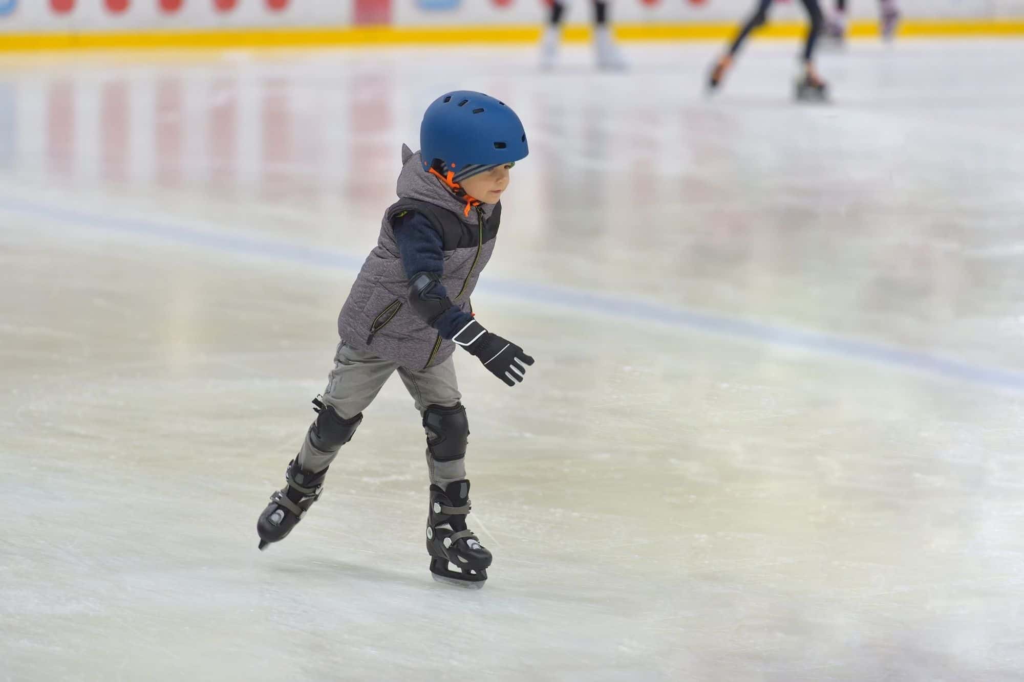 Young boy learning on hockey skates