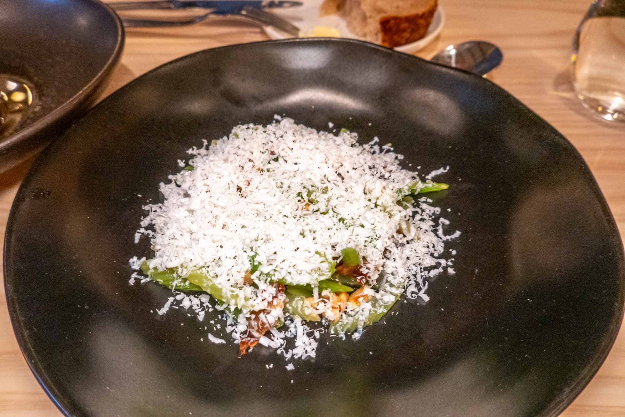 Celery salad topped with shaved cheese