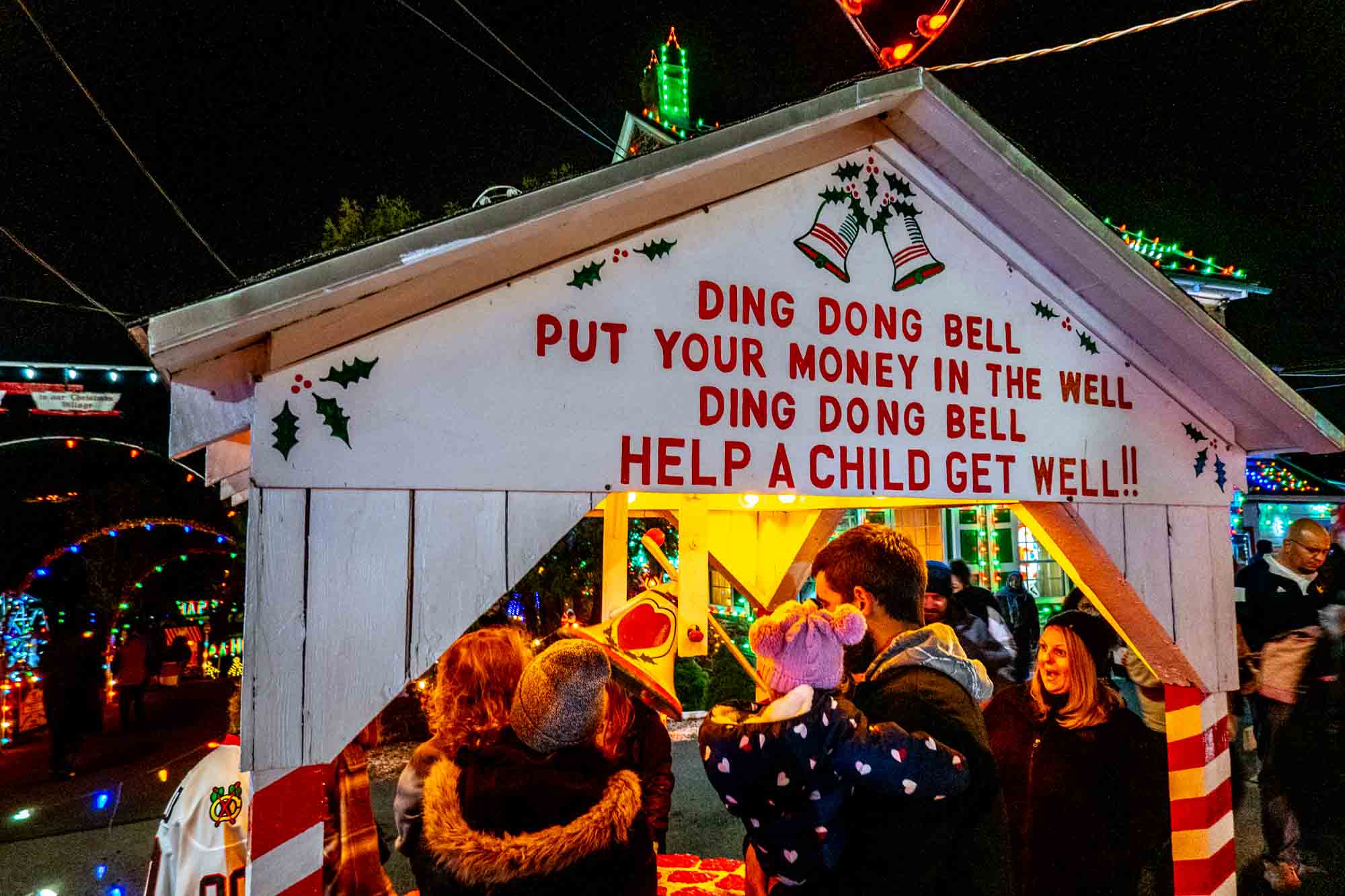 Covered charity wishing well with sign that says, "Ding Dong Bell; Put Your Money in the Well; Ding Dong Bell; Help a Child Get Well!!"