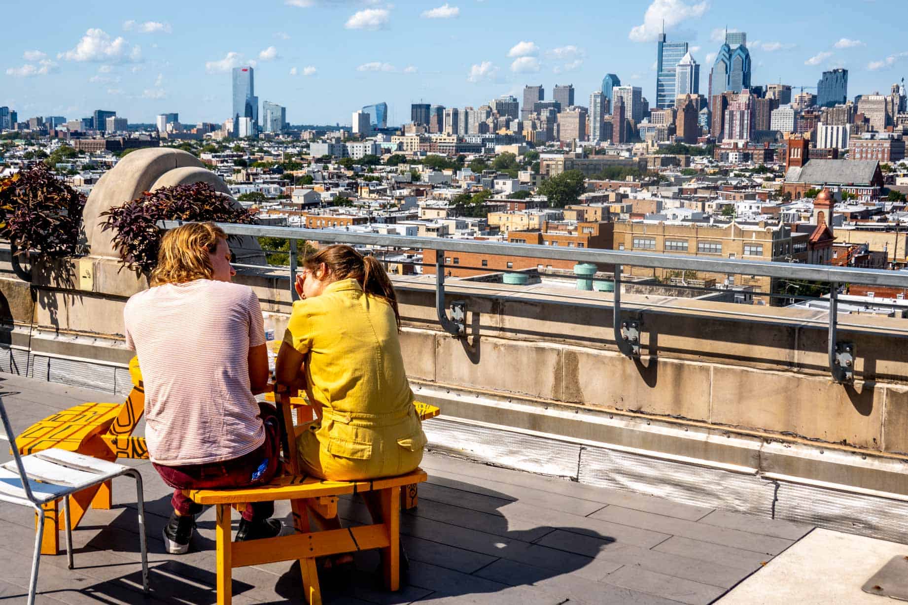 Couple at a table overlooking the Philadelphia skyline.