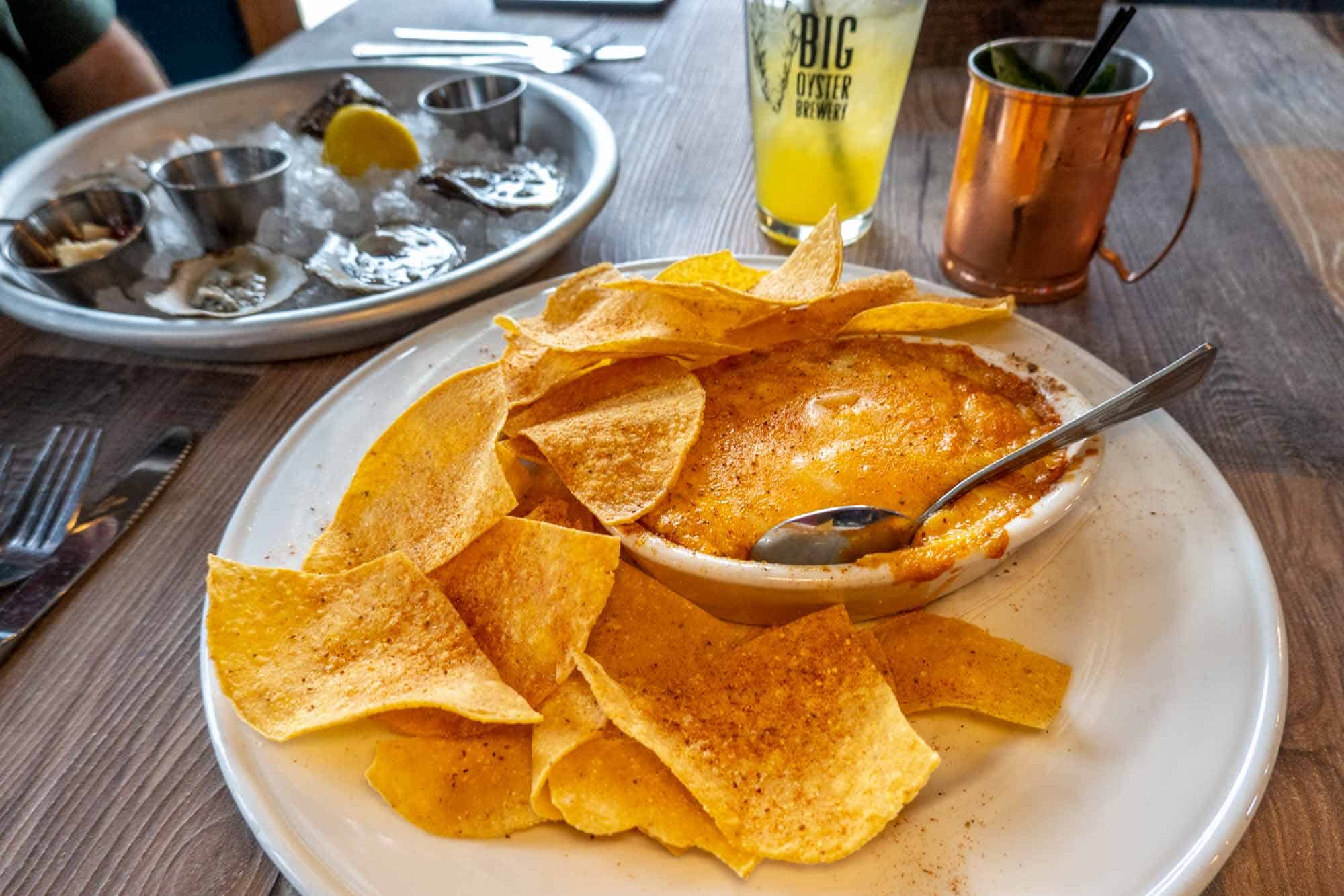 Crab dip and tortillas with oysters and drinks on a table in a Rehoboth Beach restaurant