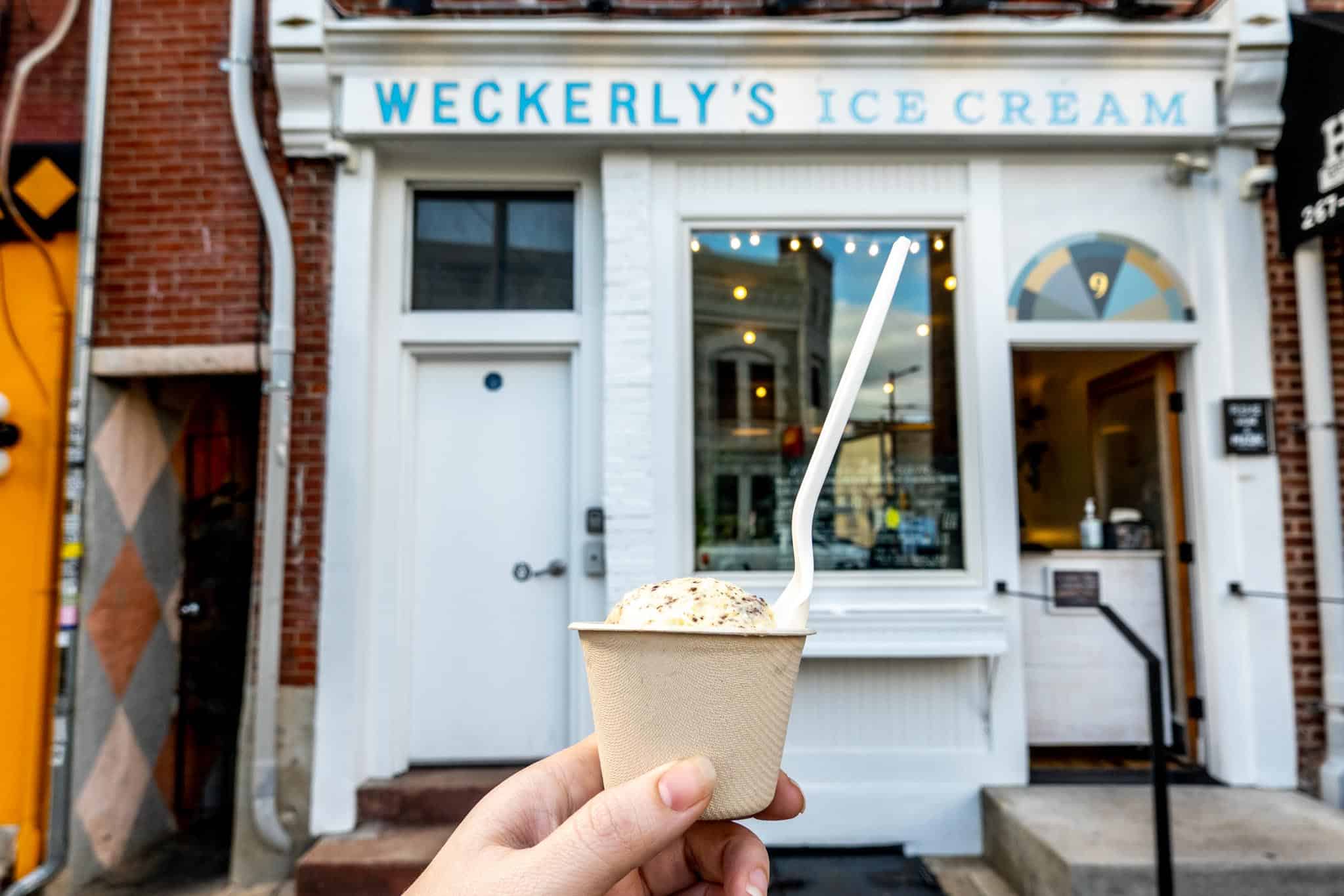 Cup of ice cream in front of Weckerly's Ice Cream storefront