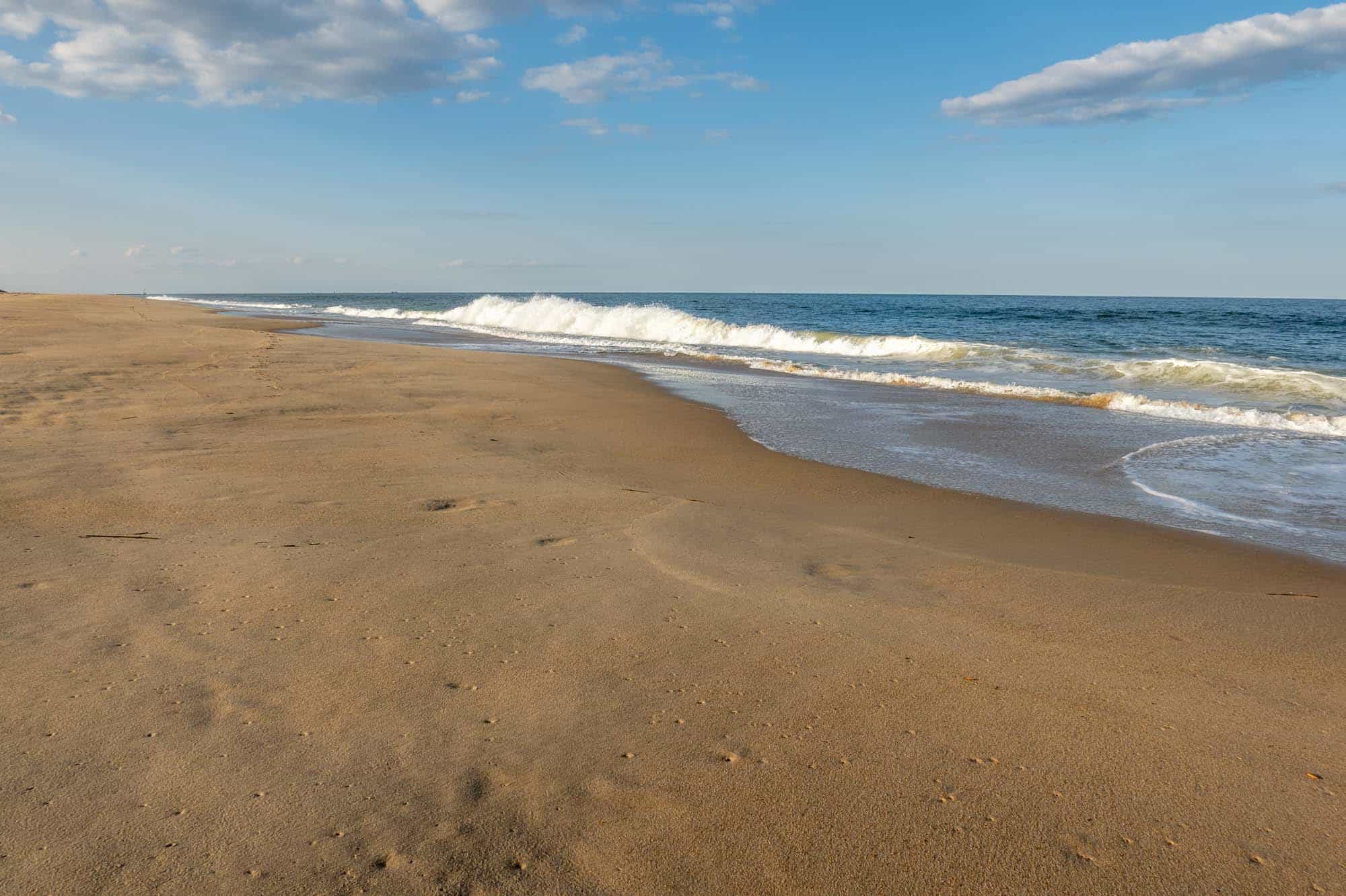 Waves hitting a golden sand beach. 