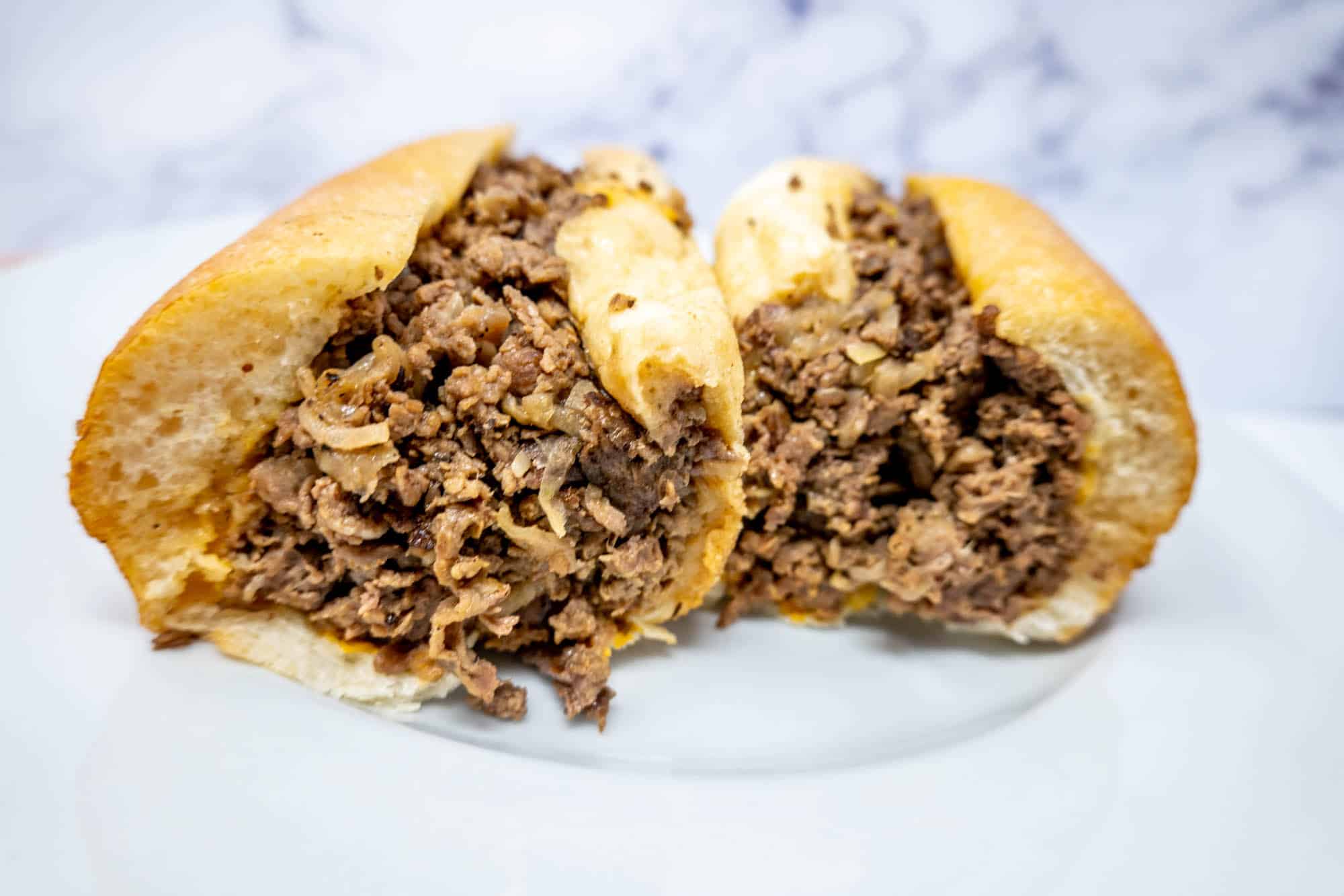 Cheesesteak cut in half.