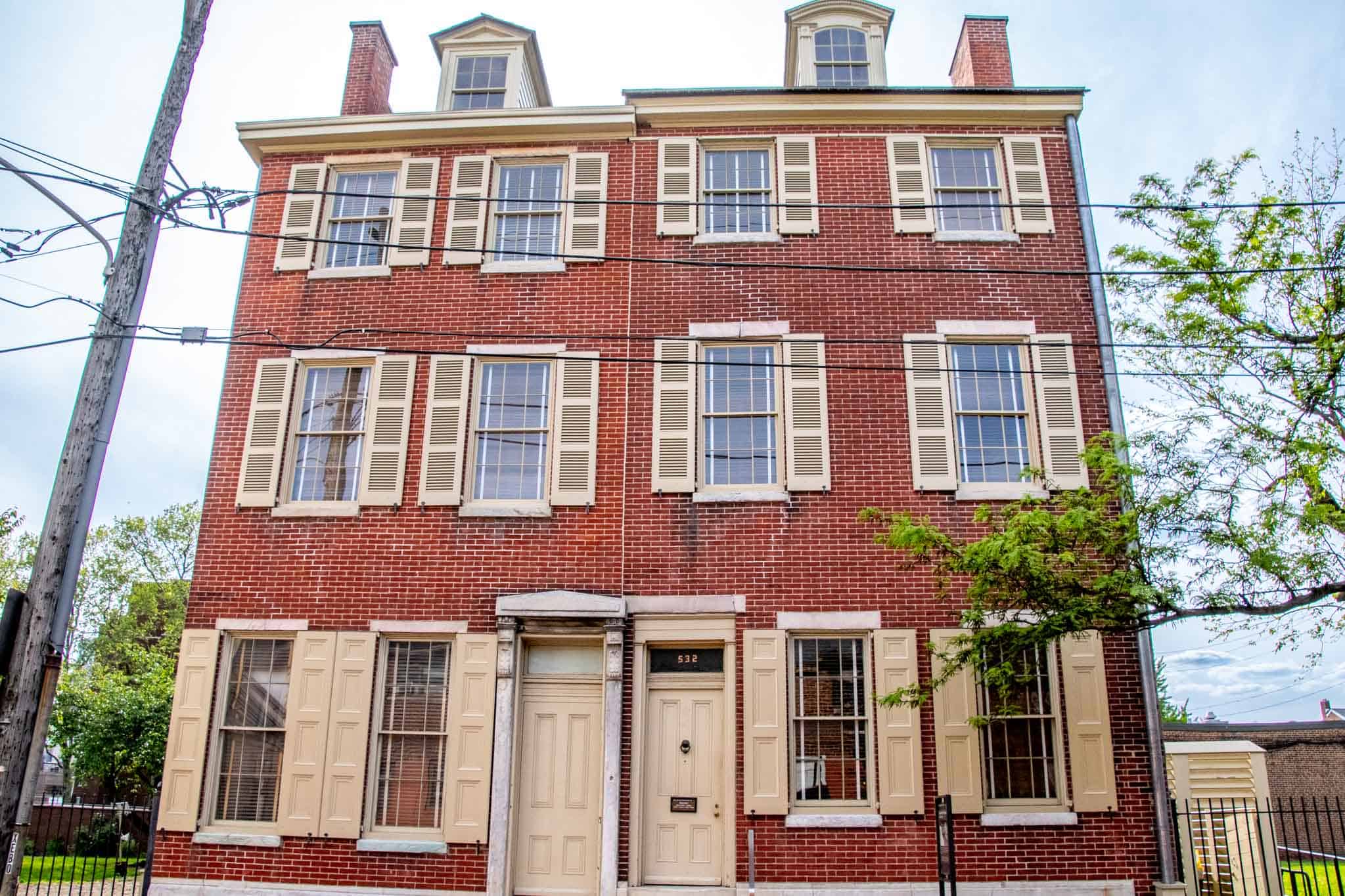 Red brick building with rows of windows and two doors