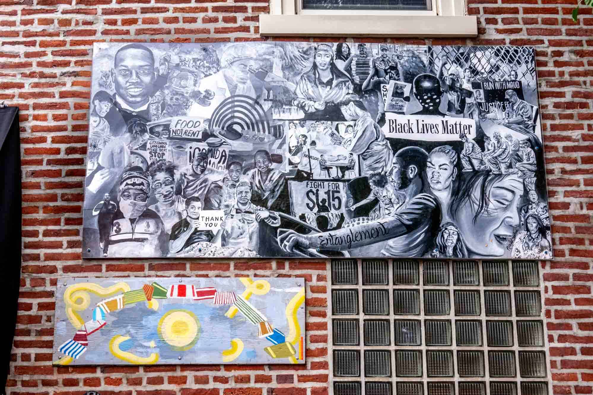 Black and white mural of people with phrases of social consciousness and political action included