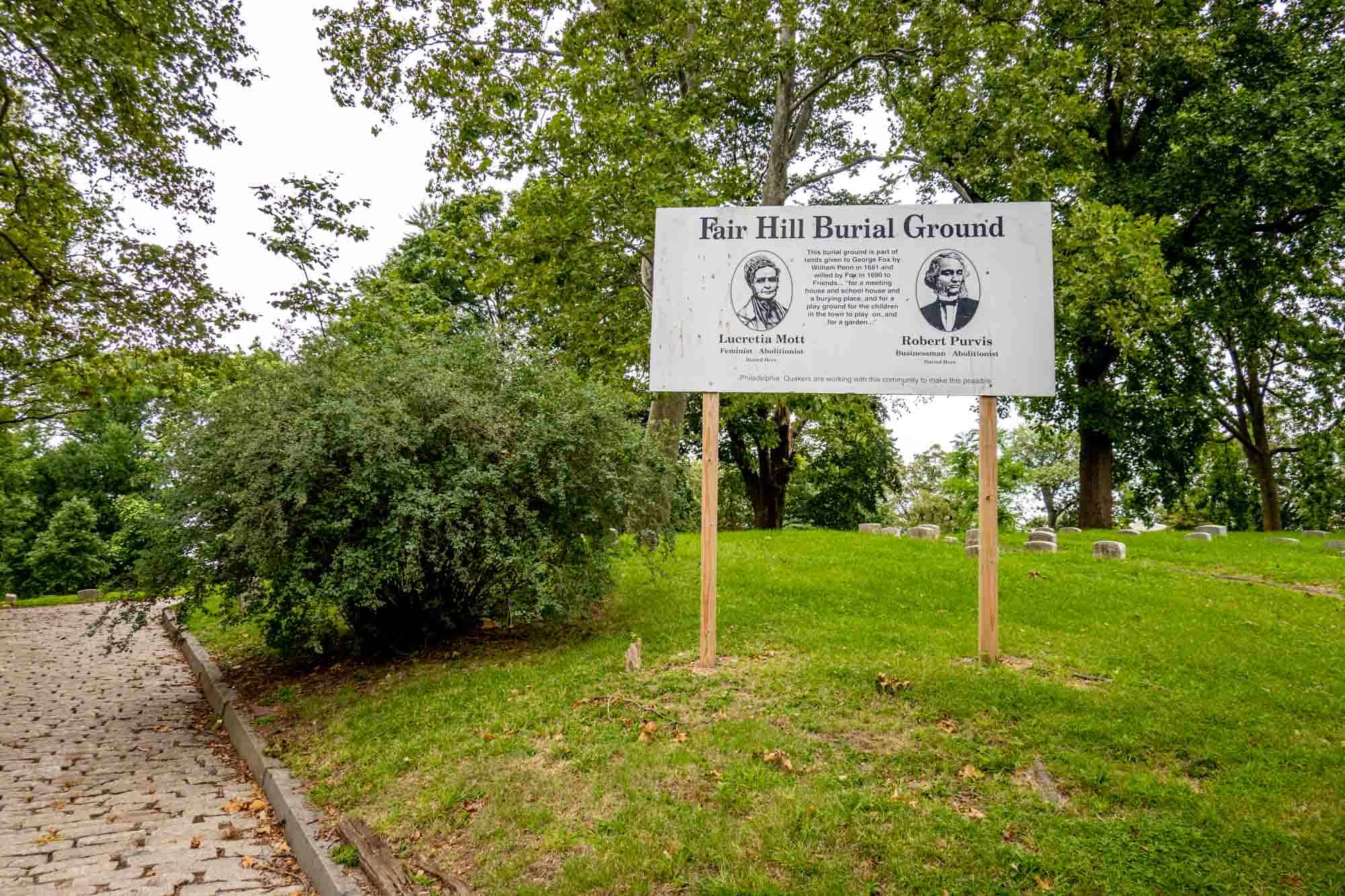 Sign at Fair Hill Burial Ground with portraits of Lucretia Mott and Robert Purvis.