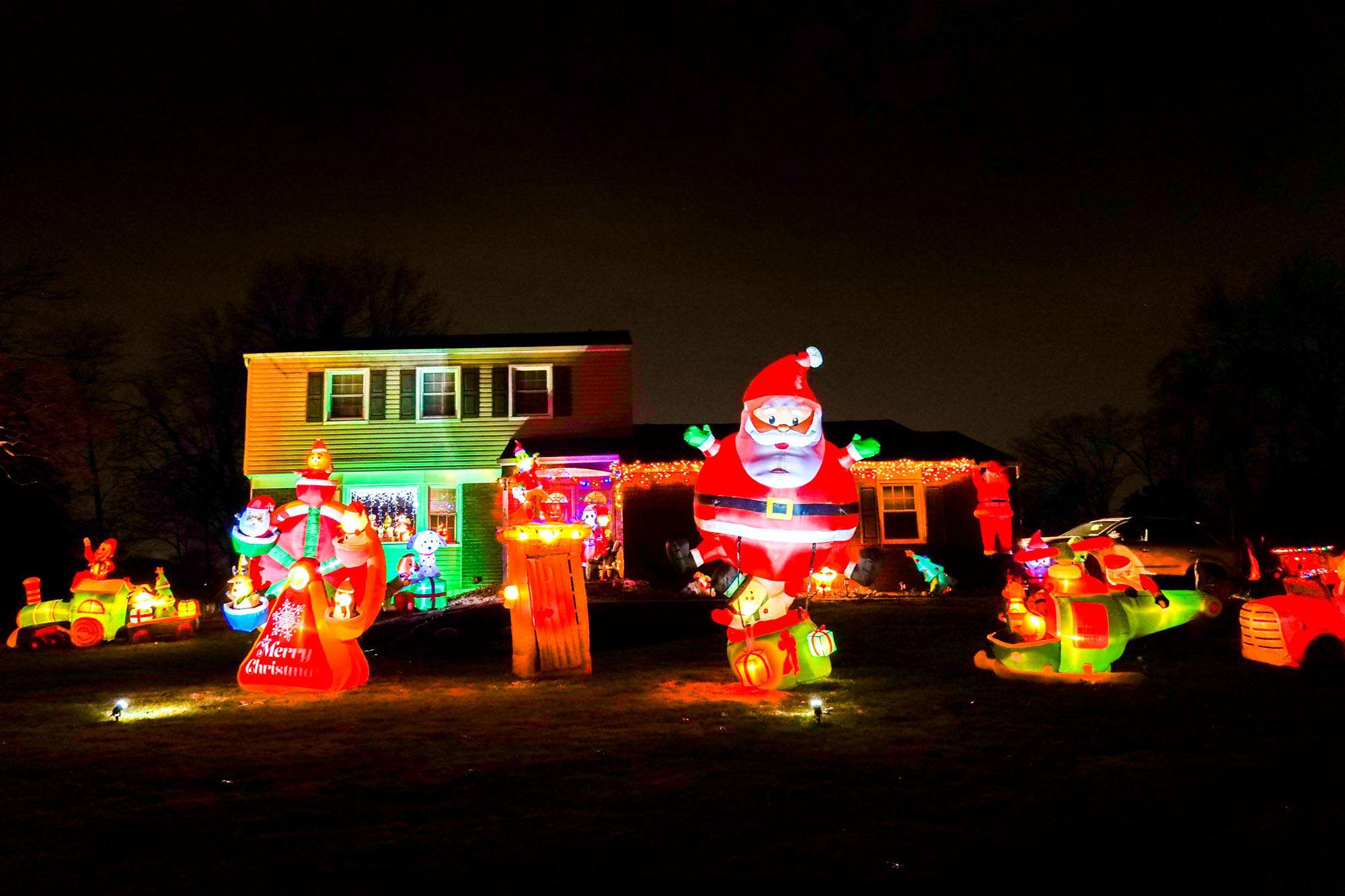 Inflated Christmas lawn decorations, including a Santa.