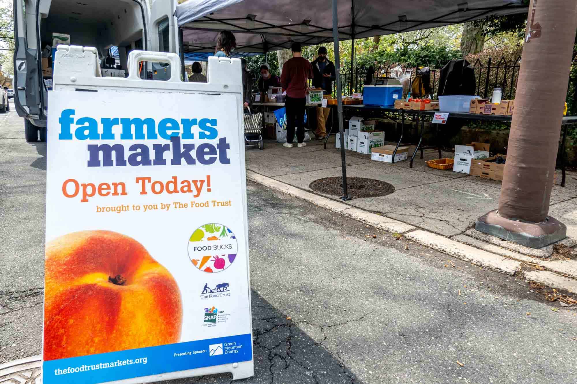 Sign reading "farmers market open today!"