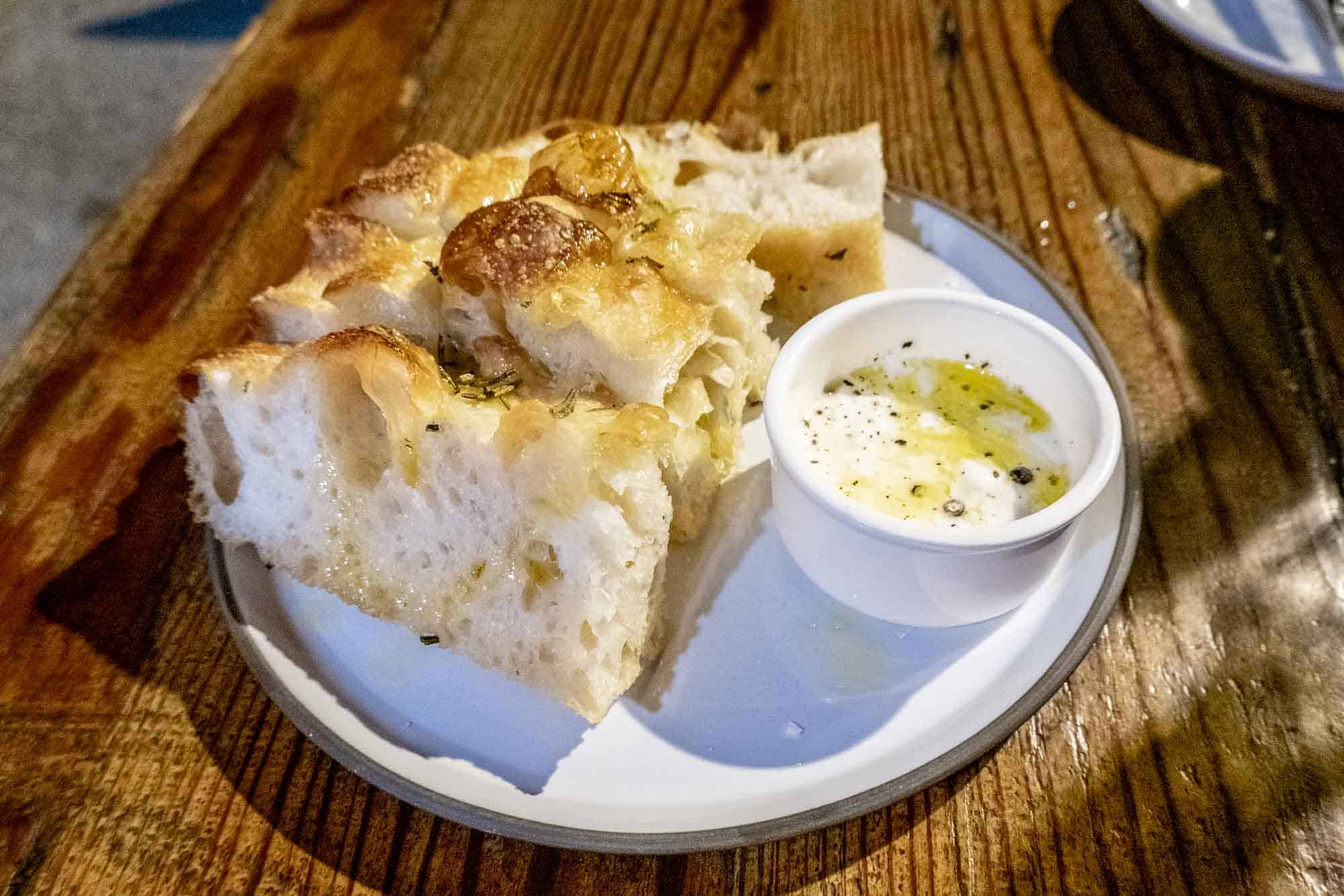 Focaccia bread with stracciatella spread on plate