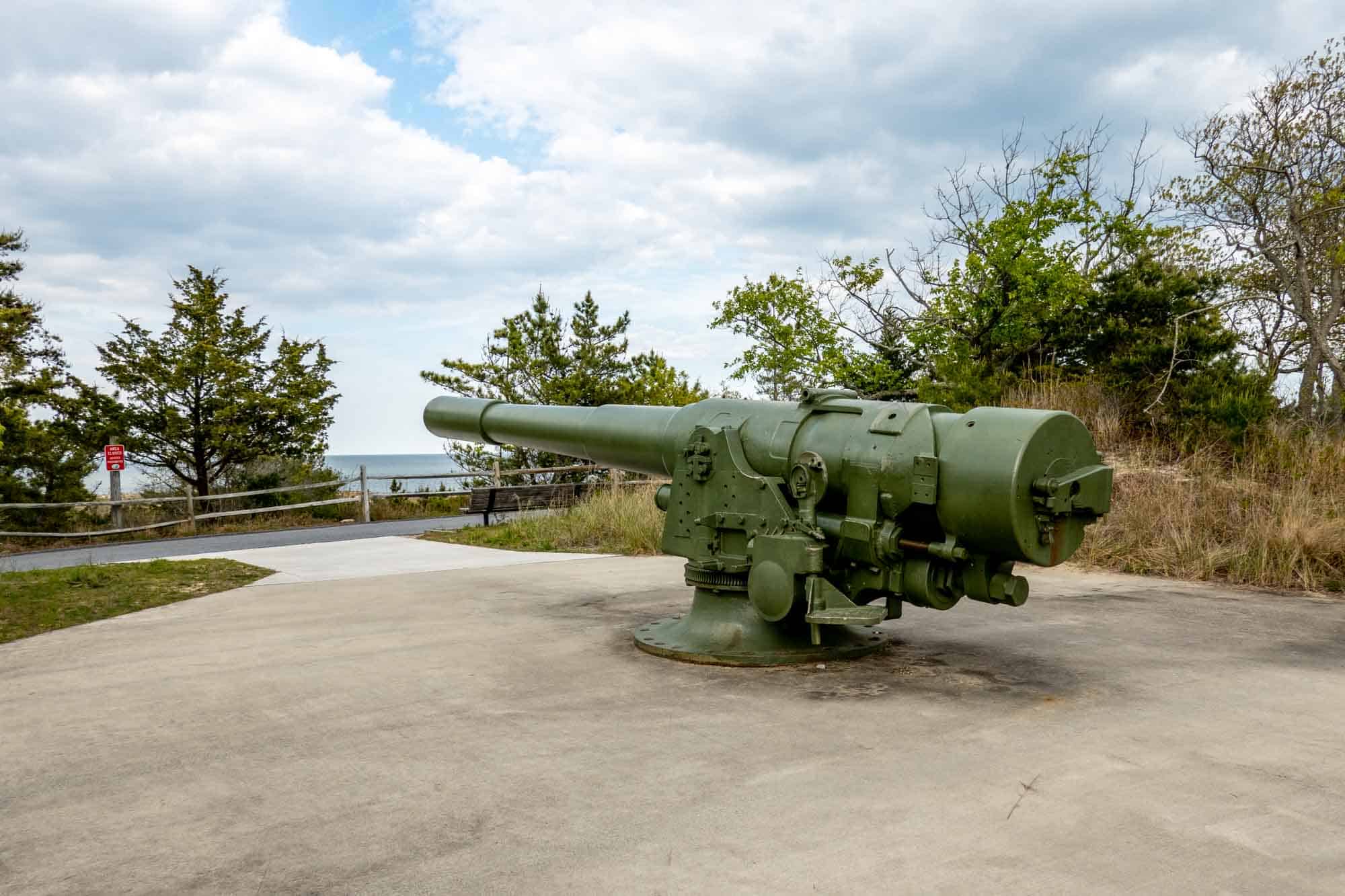 Large piece of World War II artillery on display outdoors