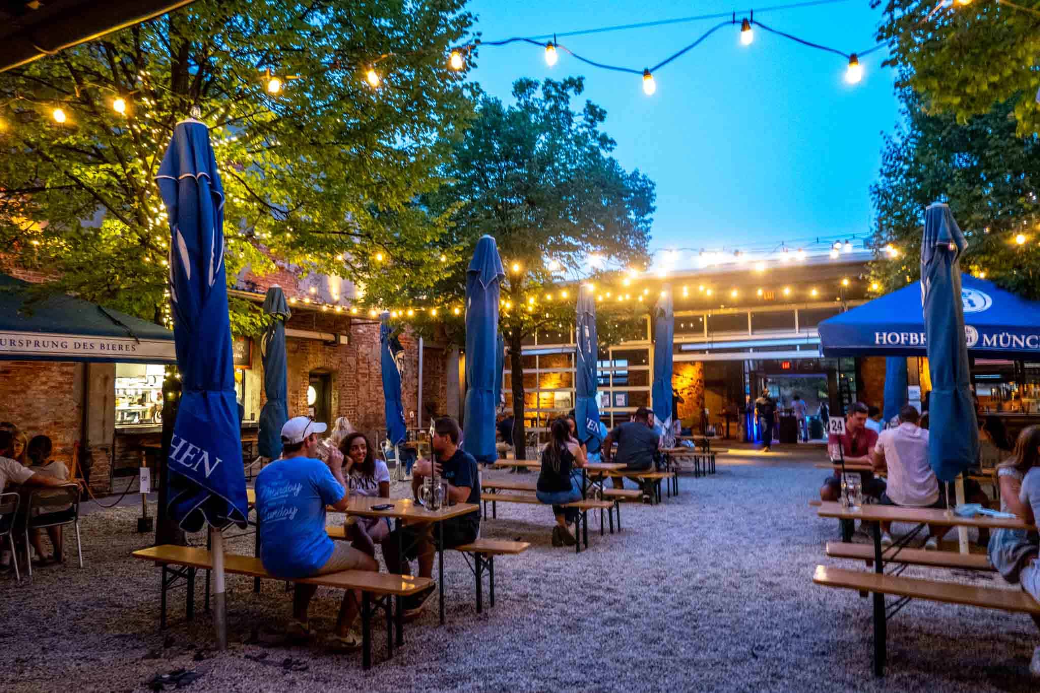 People sitting at picnic tables in a beer garden