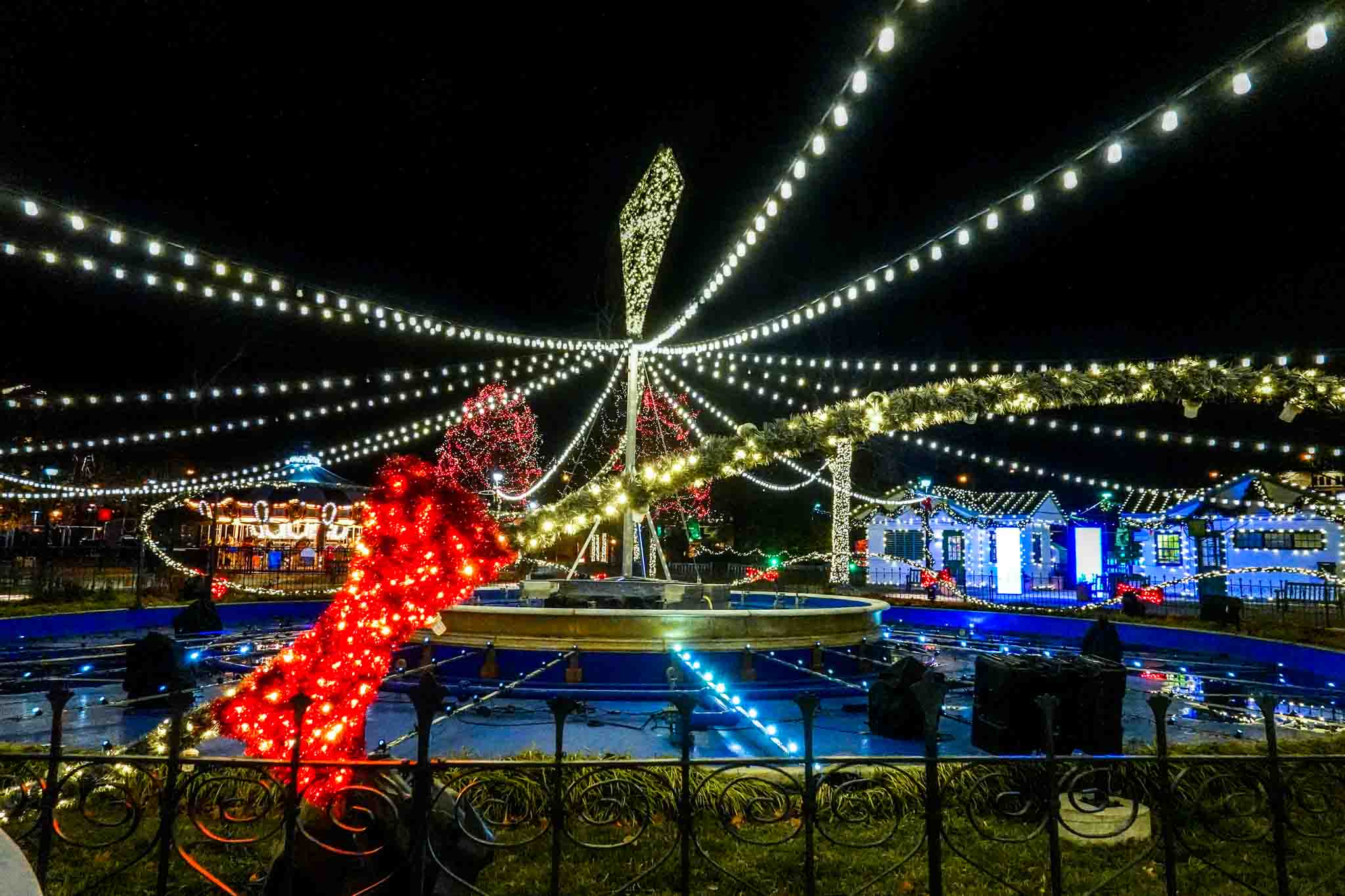 Strings of lights across a city square at night