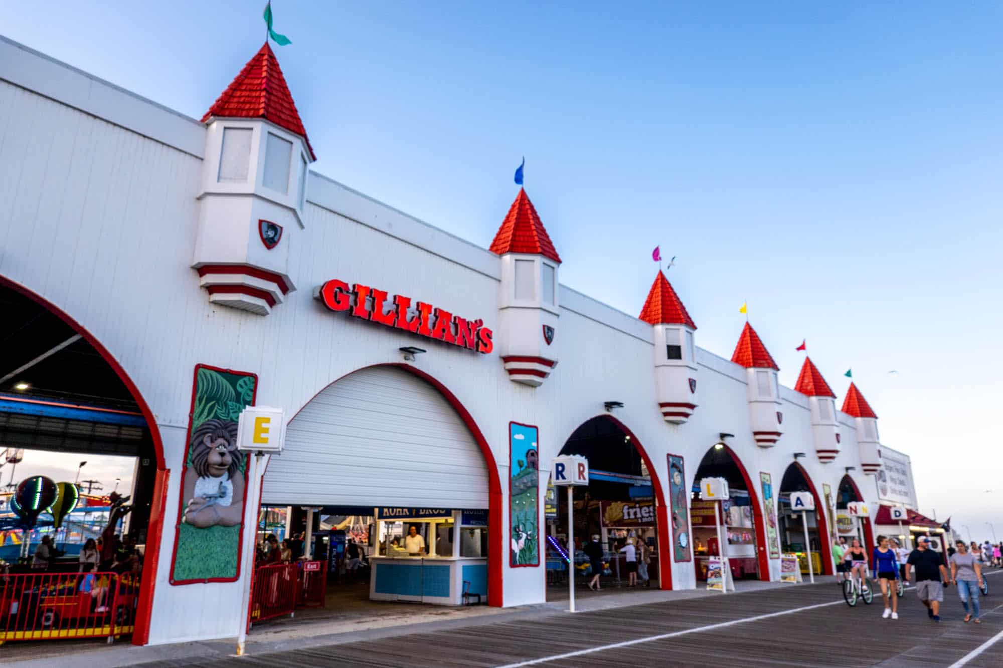 Exterior of a white building with red turrets and a sign for "Gillian's" with arcade games visible inside.