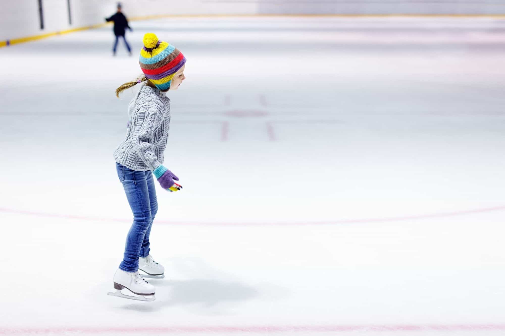 A young girl learning to ice skate