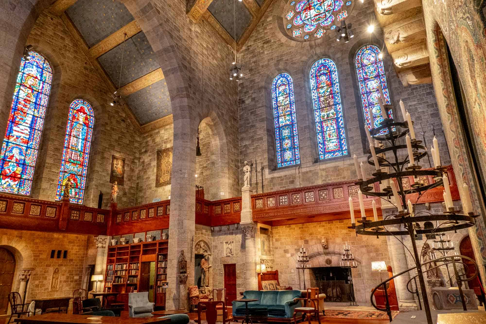 Great Hall at Glencairn featuring vaulted ceilings, stained glass windows, and chairs and couches 