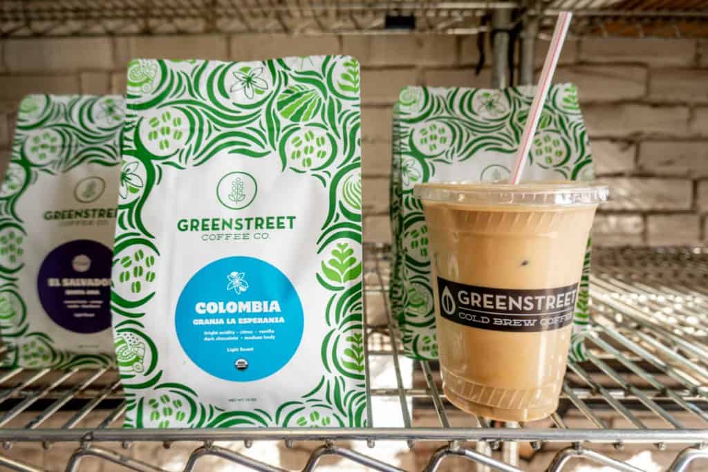 Cup of iced coffee beside a bag of Greenstreet coffee