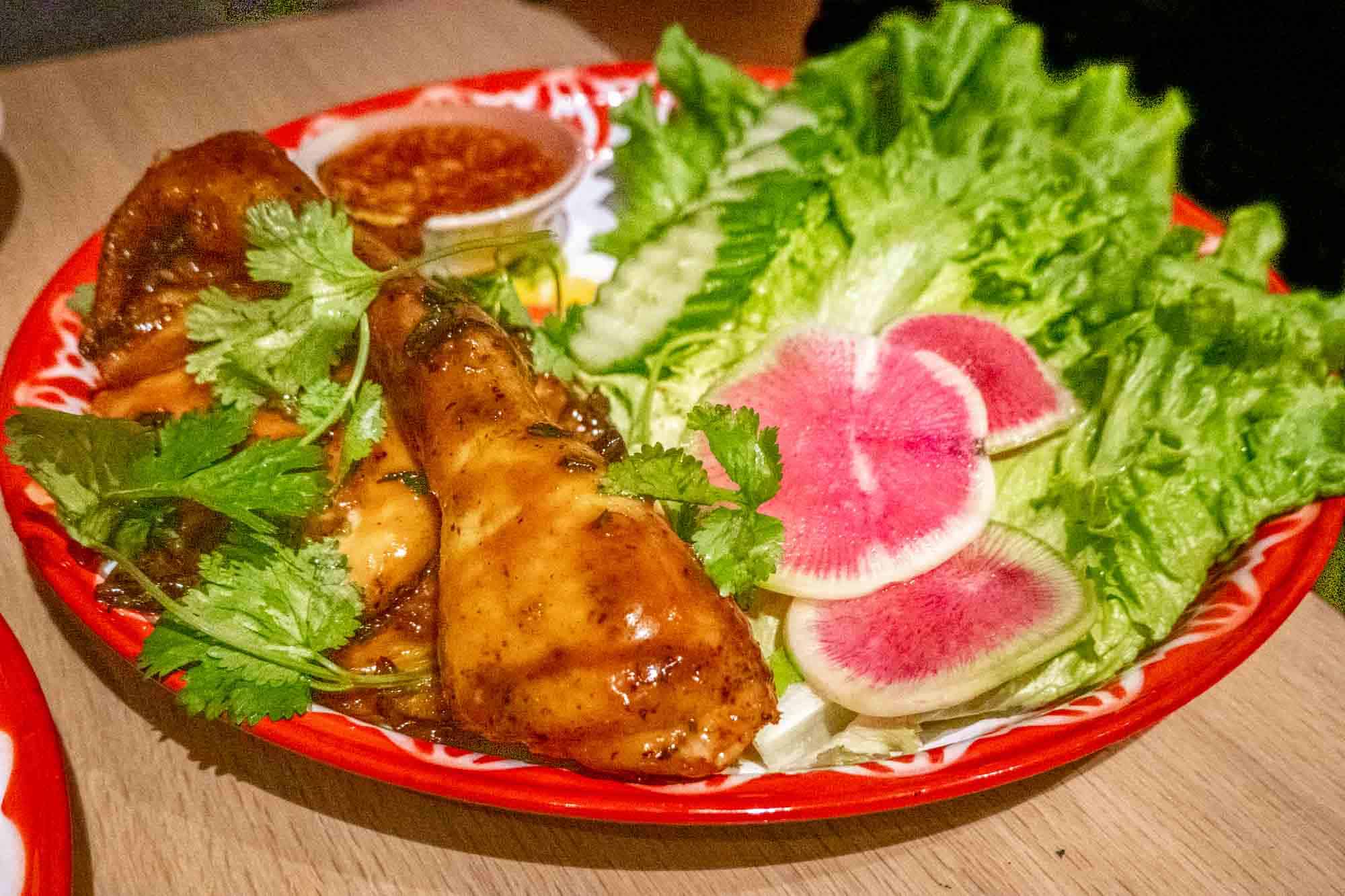 Grilled chicken in soy glaze with radish and lettuce.