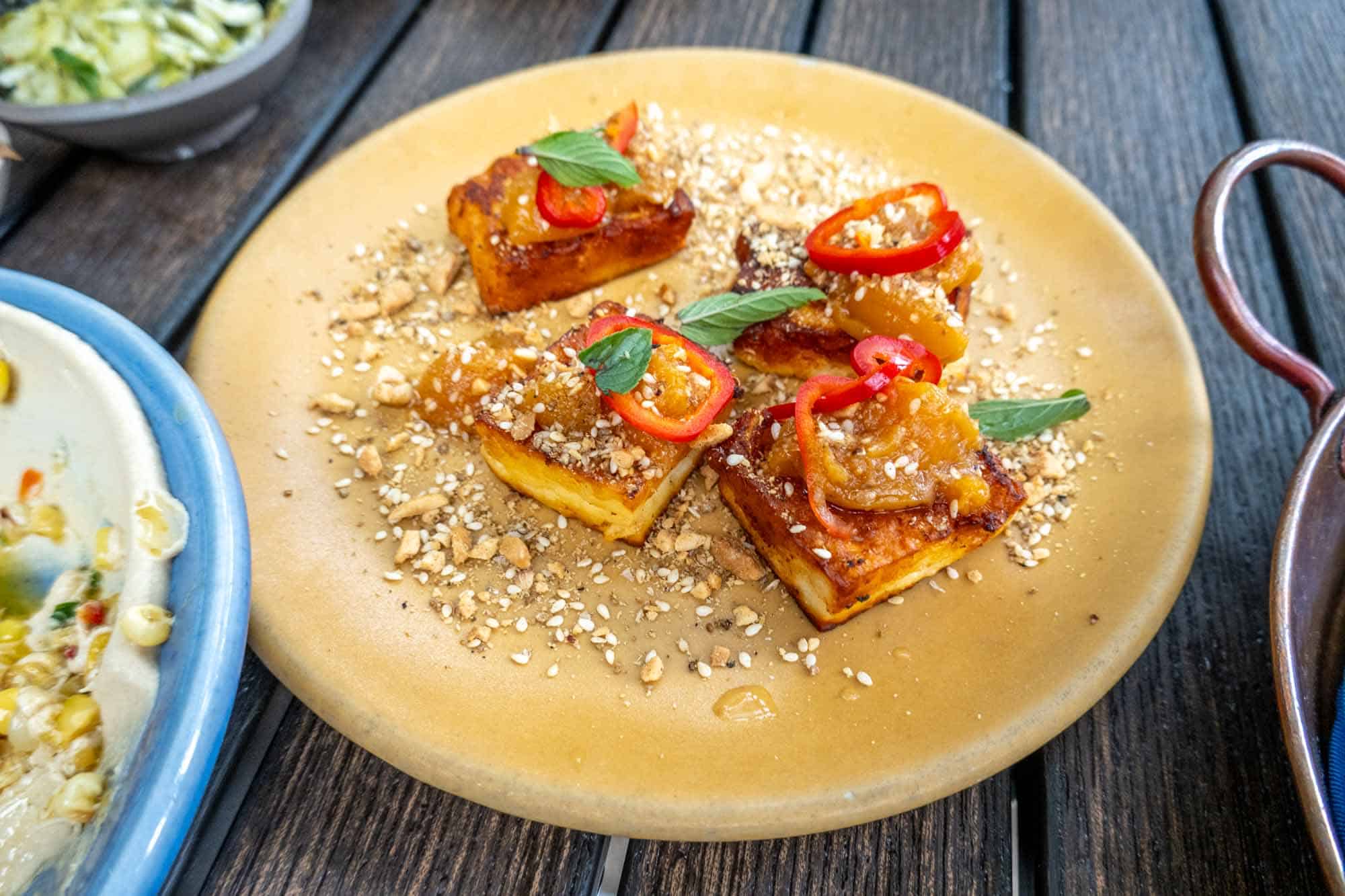Fried haloumi cheese topped with red peppers