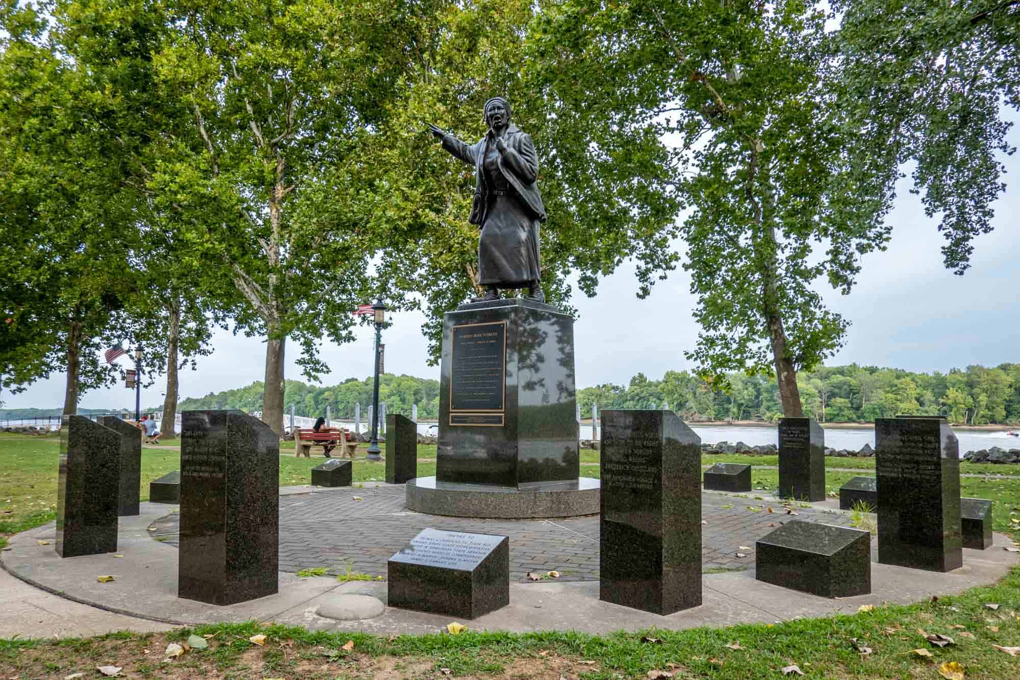 Statue of a woman beside a river.