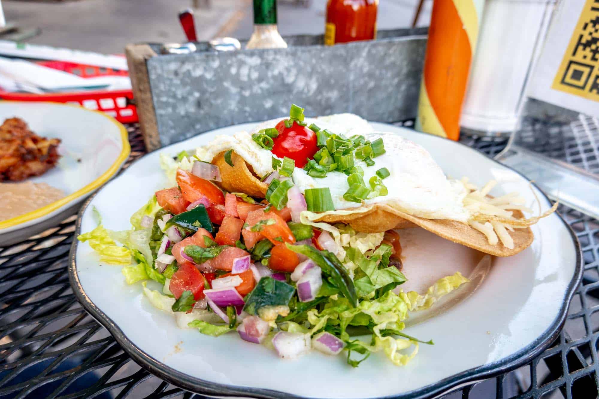 Plate of huevos rancheros on a table.