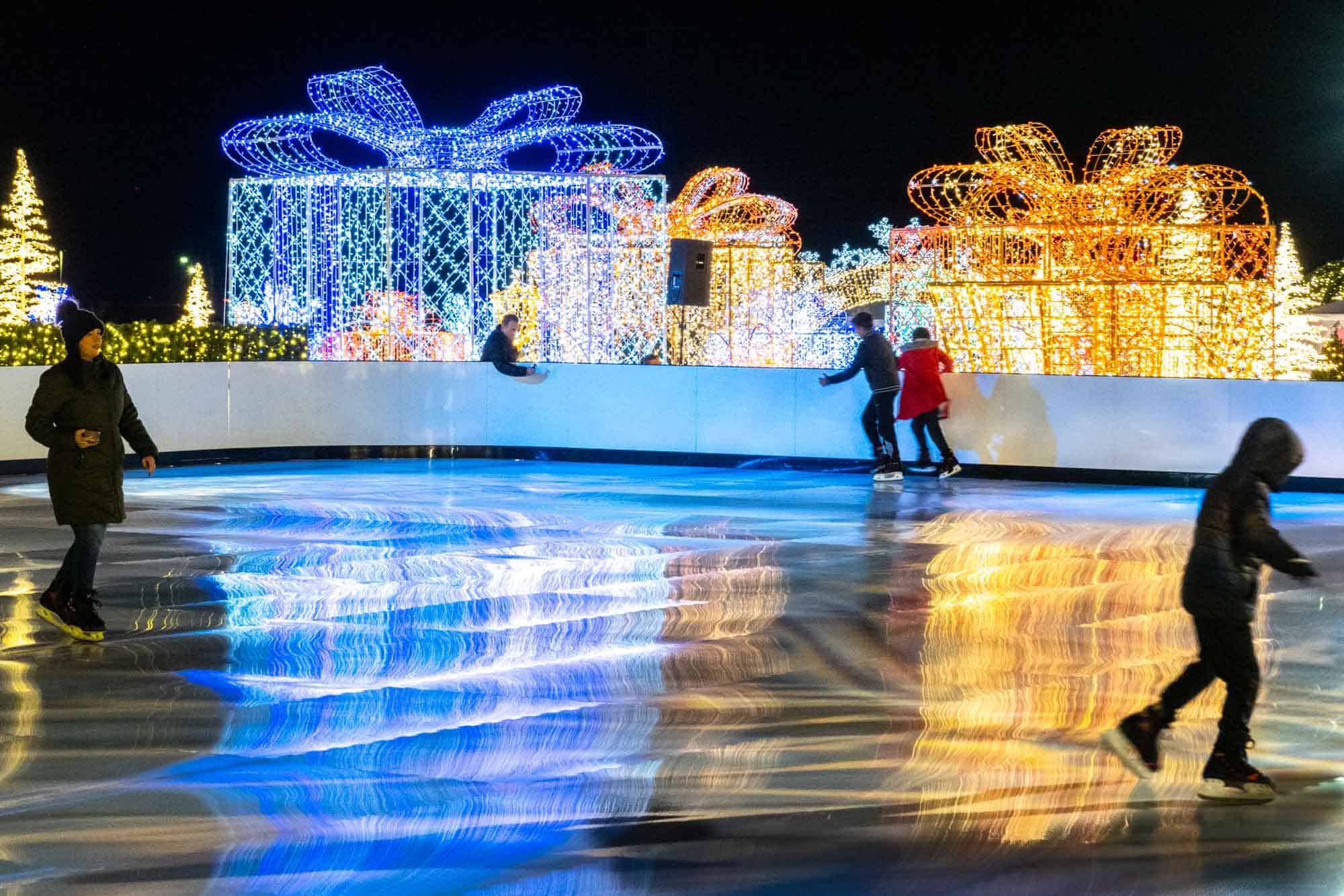 People ice skating at holiday event
