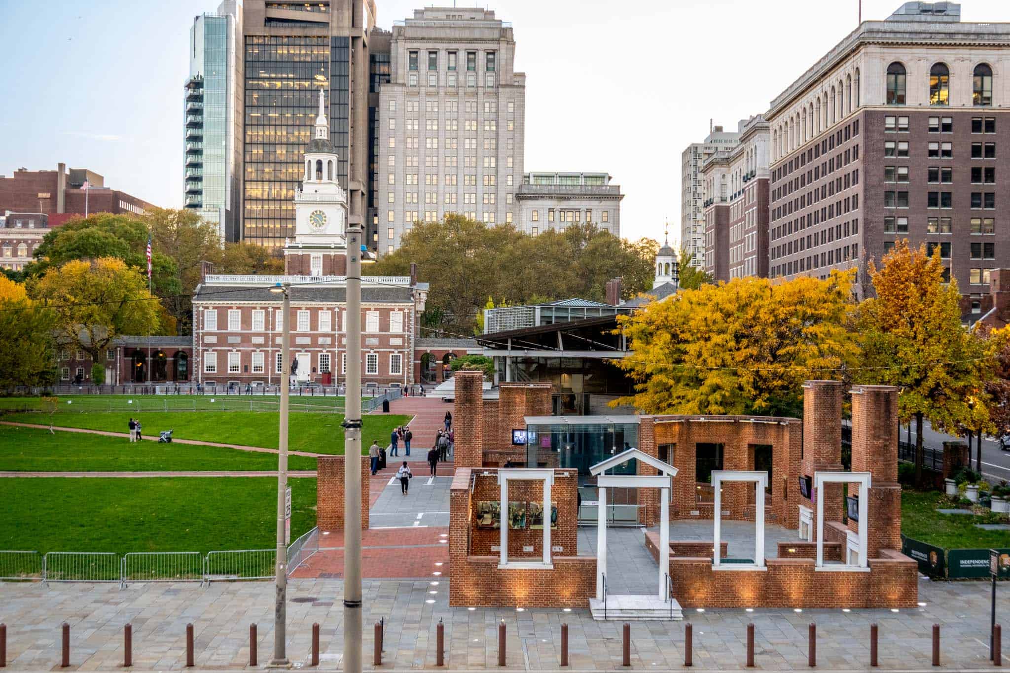 Buildings surrounding a grass-filled square.