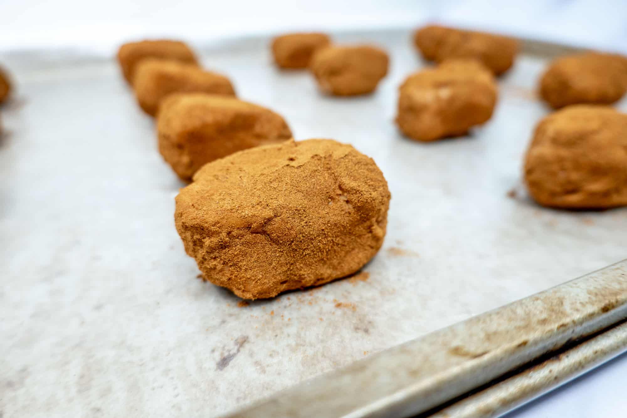 Rows of Irish potato candy on cookie sheet