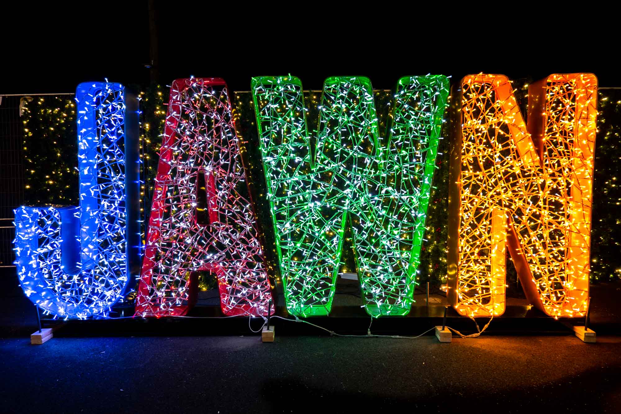Illuminated light display that says 'Jawn'