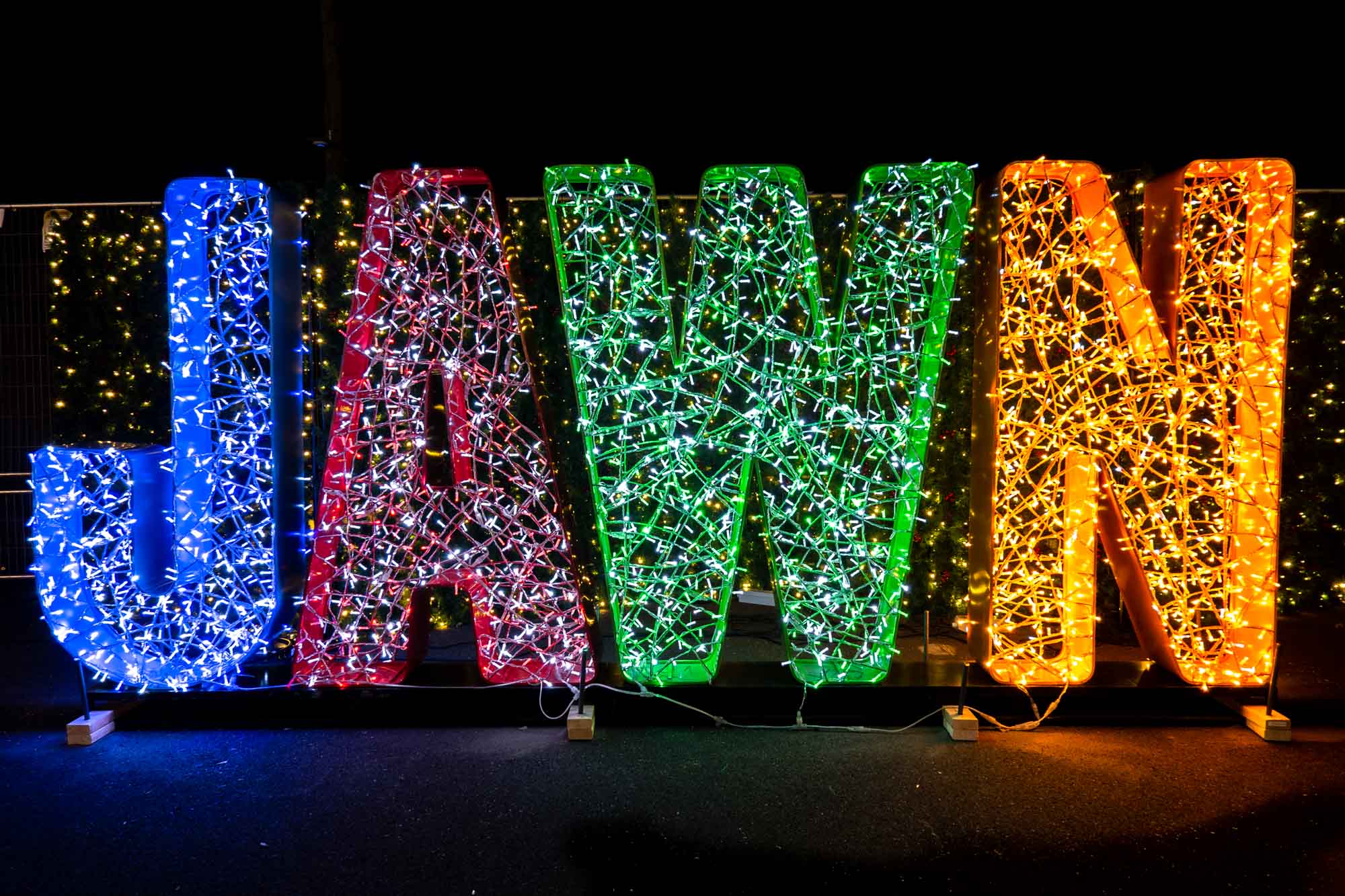 Illuminated light display that says 'Jawn.'