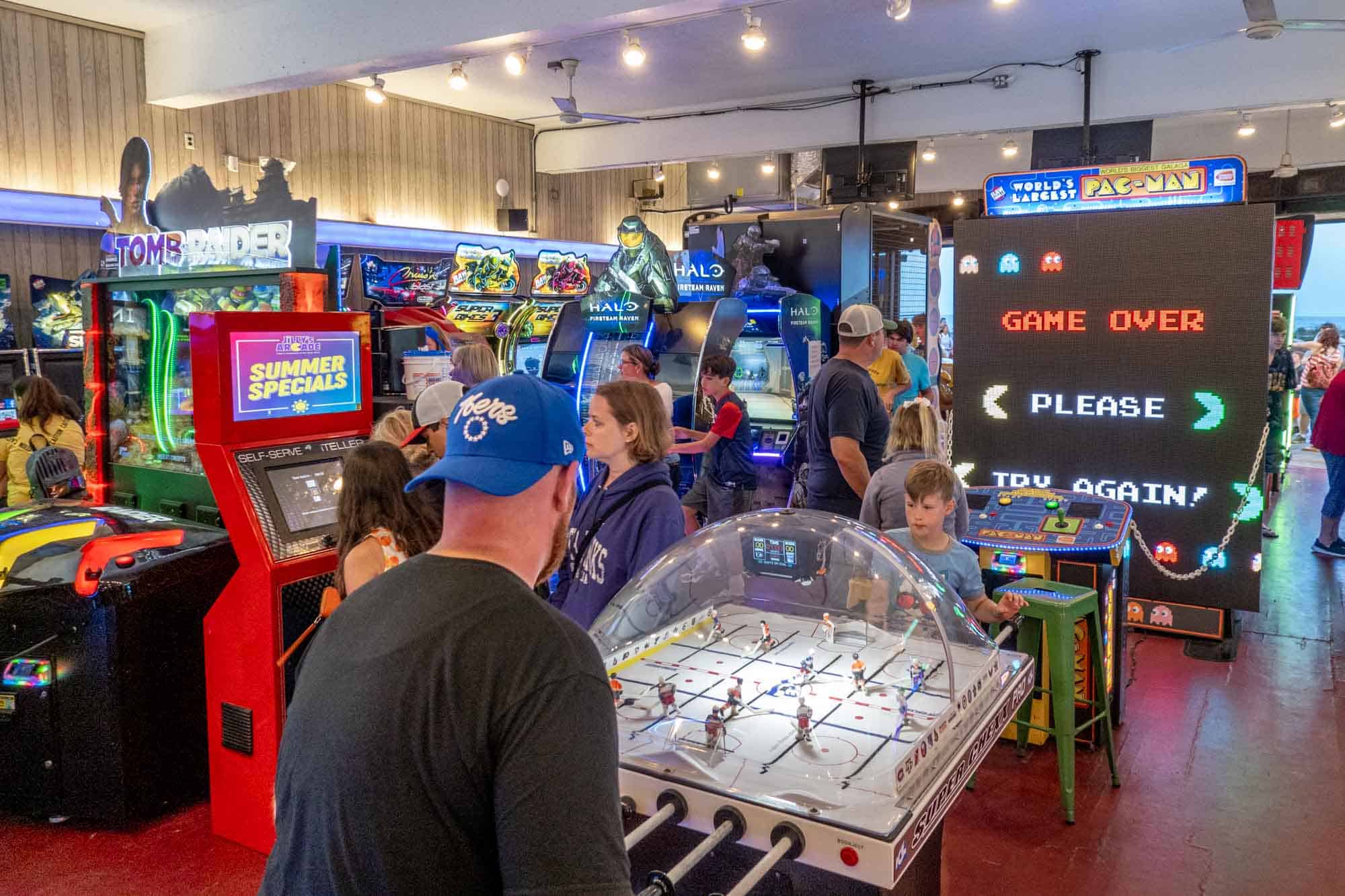 People playing foosball at an indoor arcade.