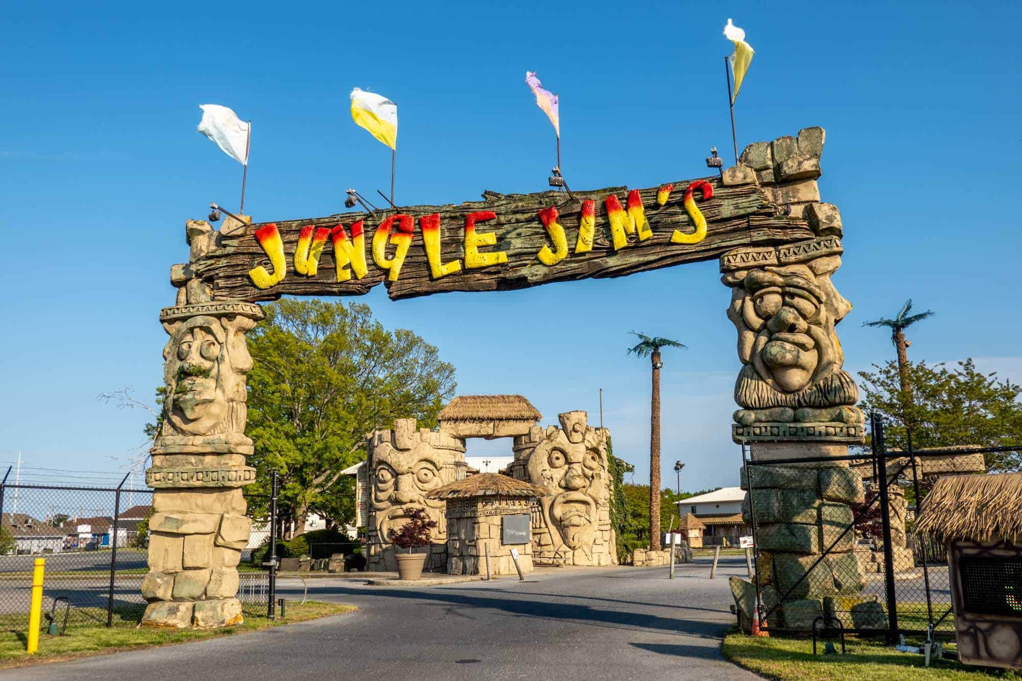 Tiki style brown sign with "Jungle Jim's" in red and yellow letters