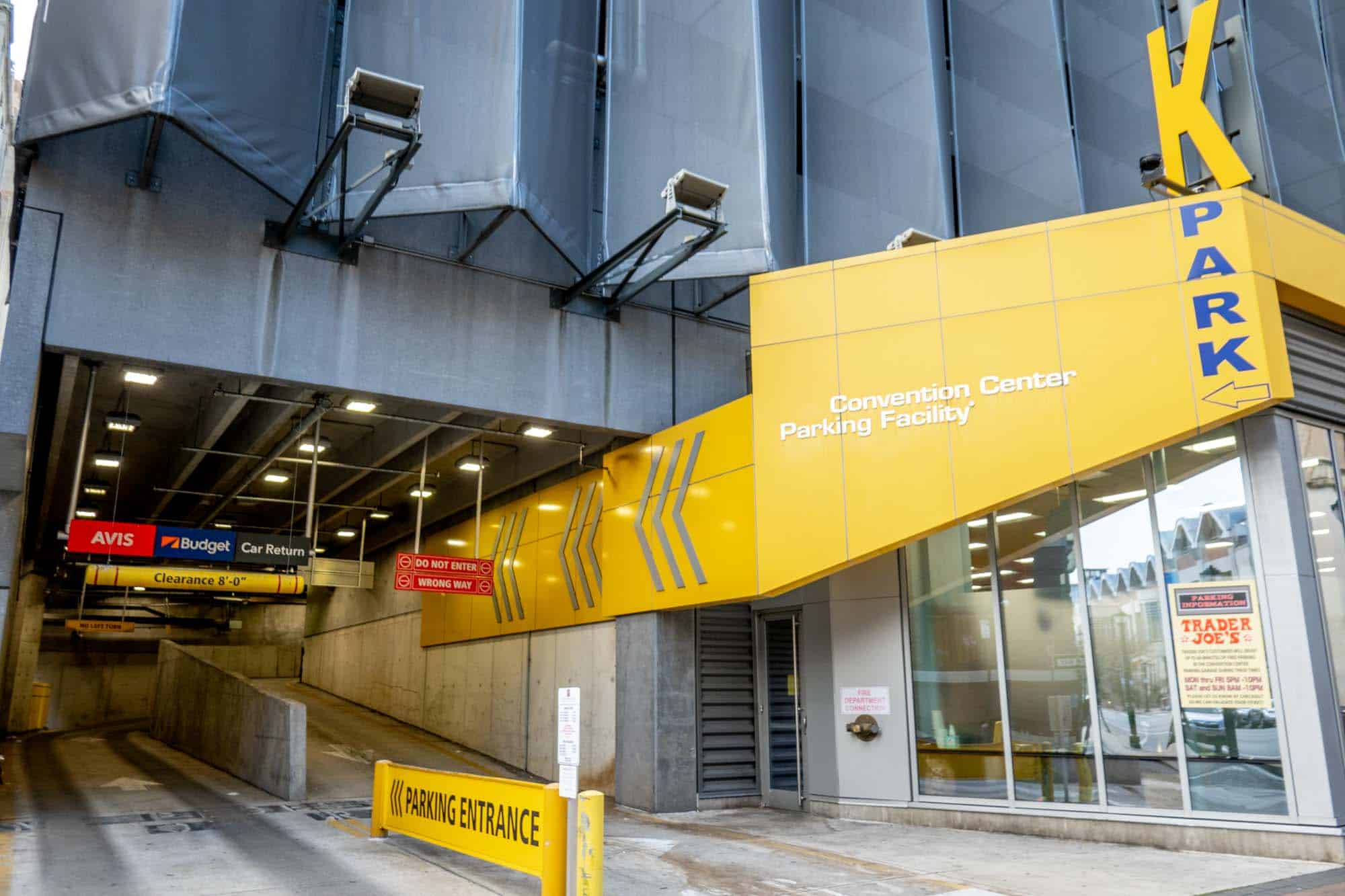 Bright yellow sign on parking garage entrance