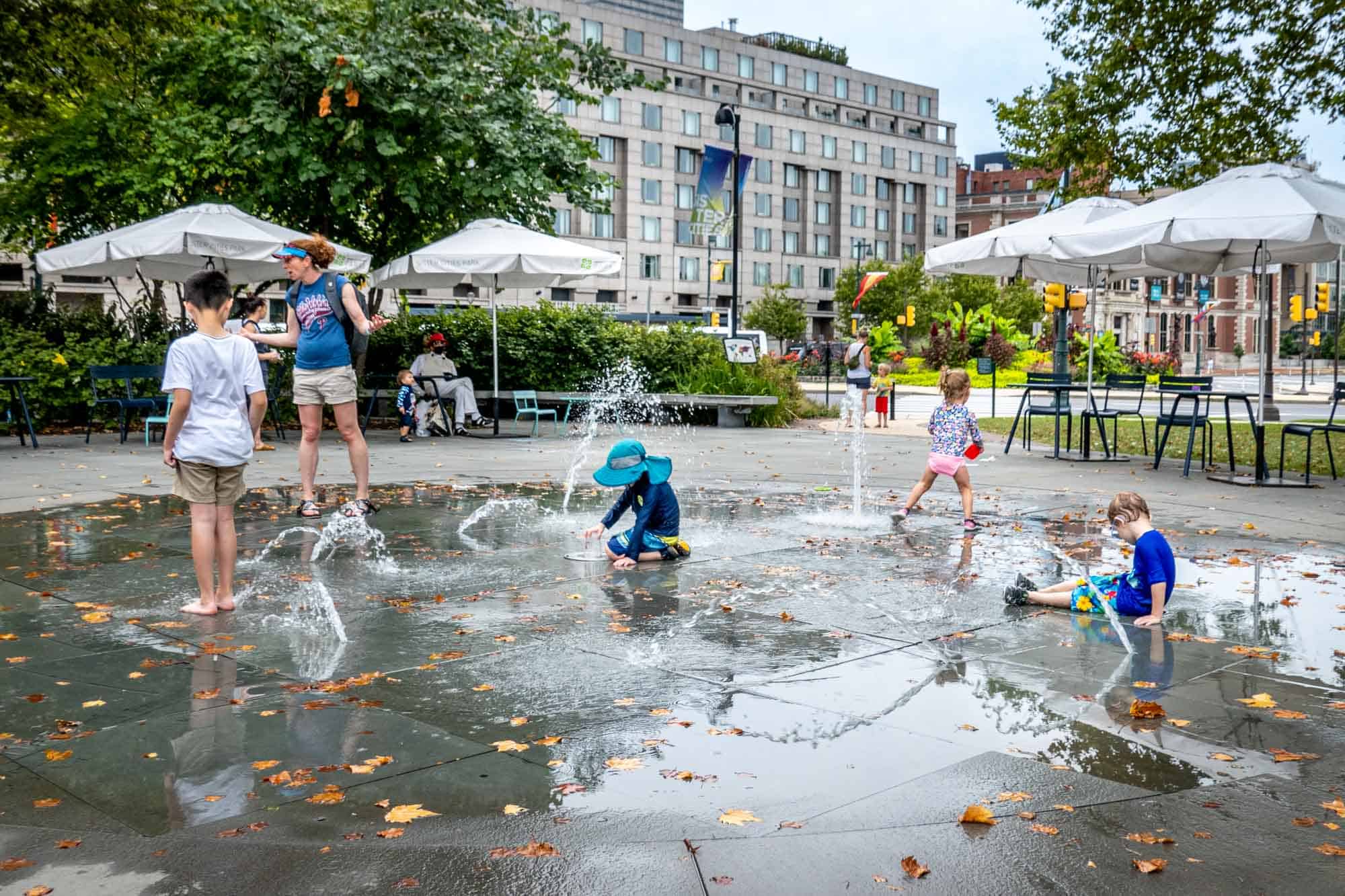 Kids playing in fountains in a park