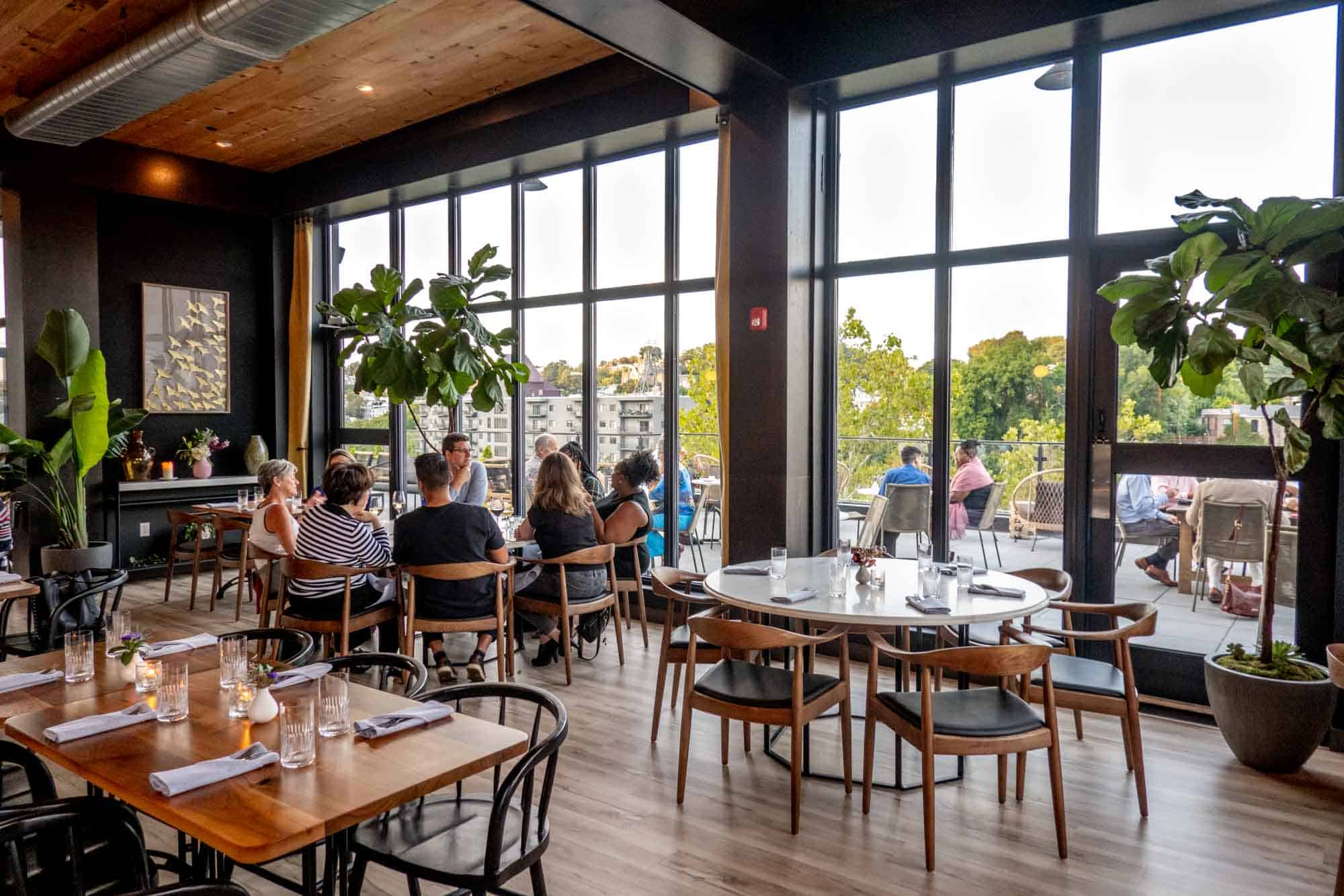 Airy restaurant dining room with floor-to-ceiling windows.