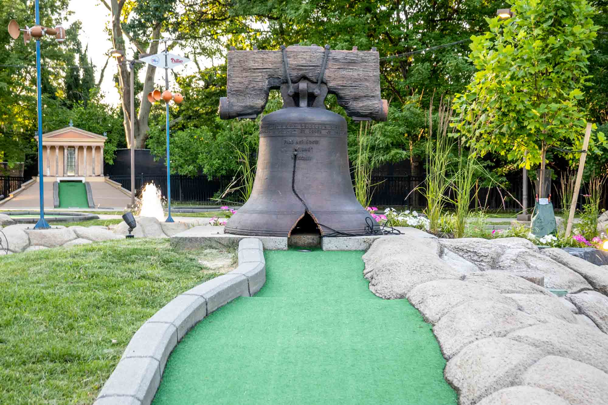 The Liberty Bell replica at a hole on a mini-golf course.