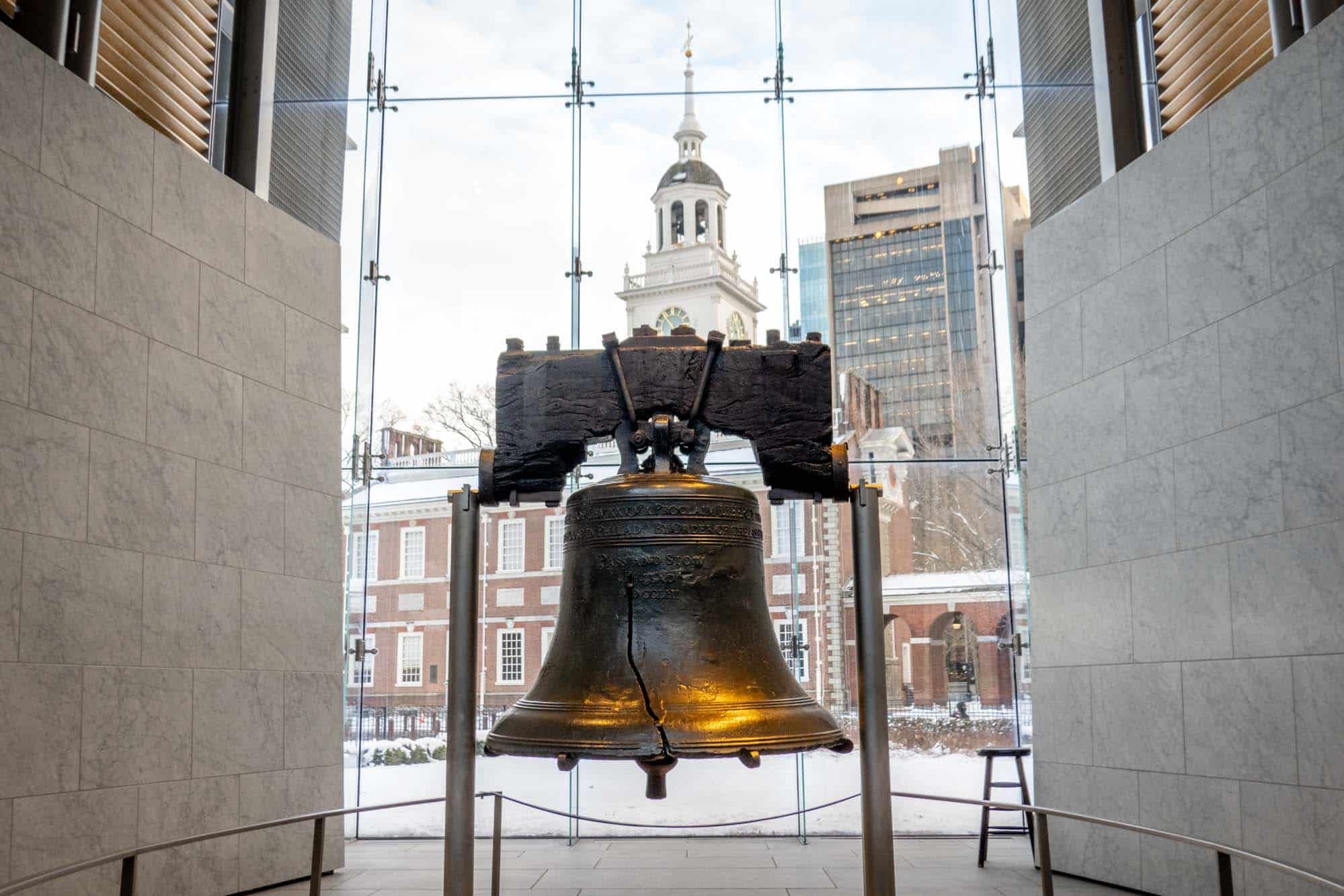 Large, cracked bell on display in a museum.