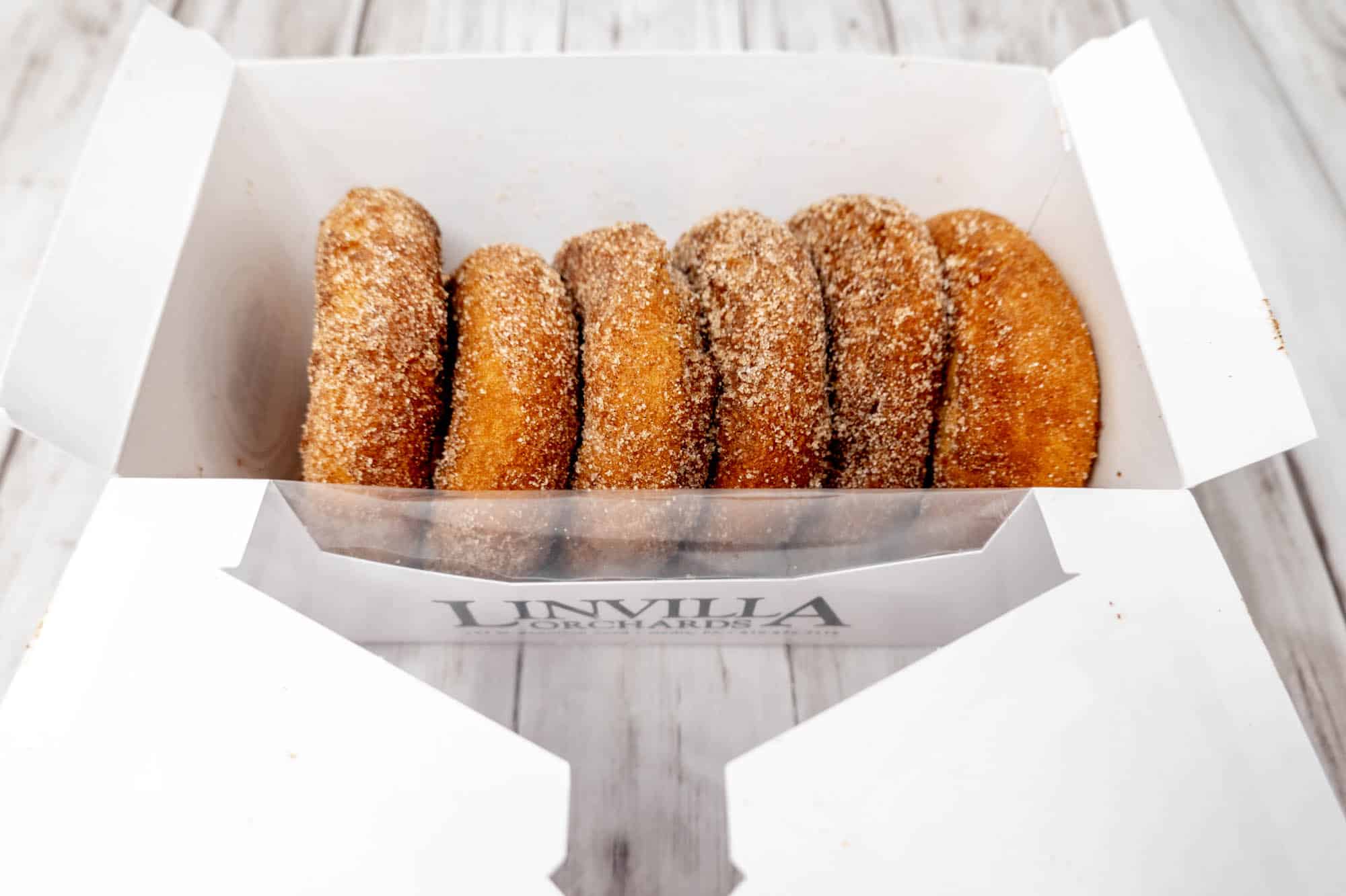 Box of a half-dozen apple cider donuts labeled "Linvilla Orchards"