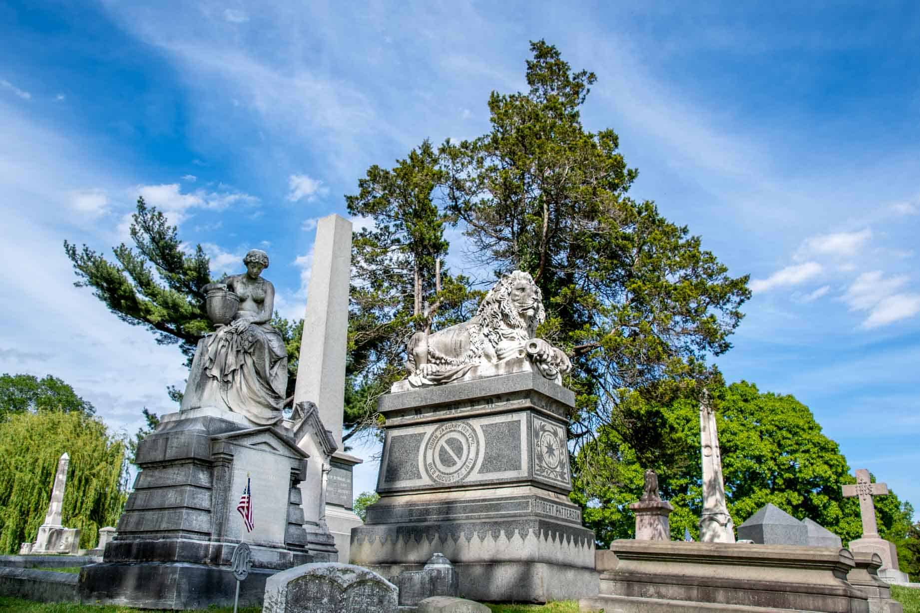 Tombs topped with sculptures of a lion and a woman