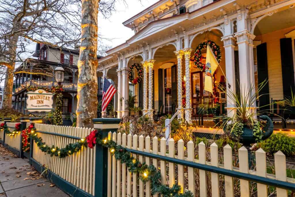 Victorian home decorated with garland and Christmas lights in Cape May