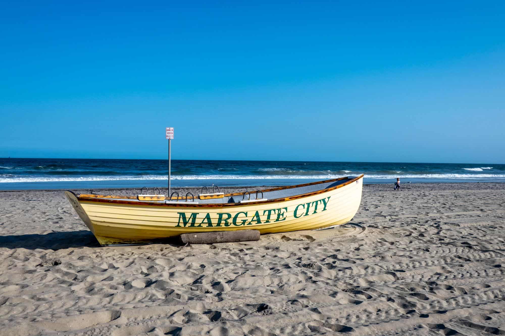 Lifeboat painted with "Margate City" on a sandy beach.