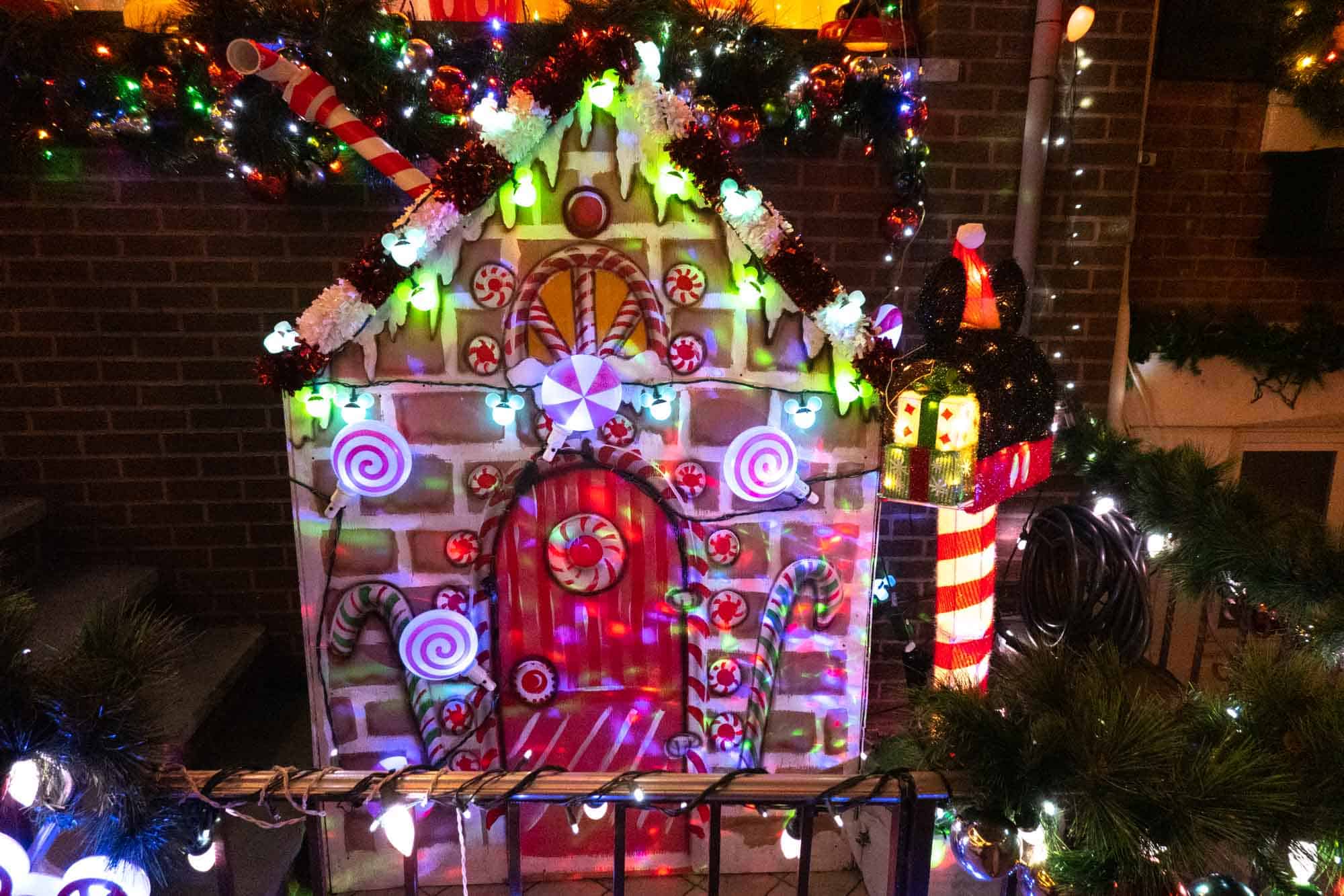 Illuminated gingerbread house Christmas display.