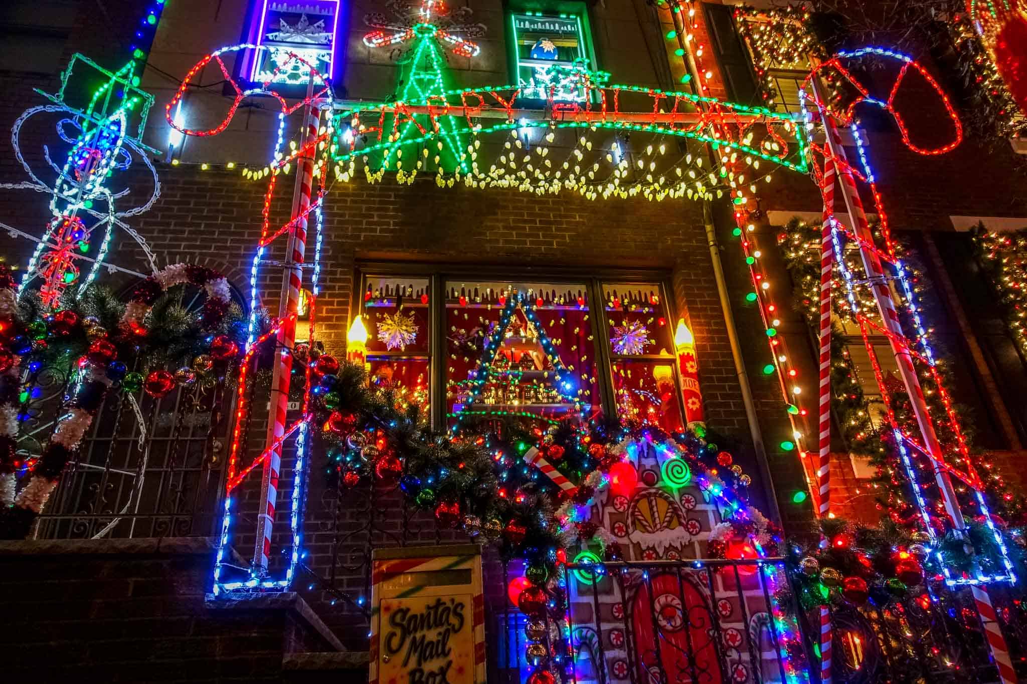 Row home with colorful Christmas lights display.